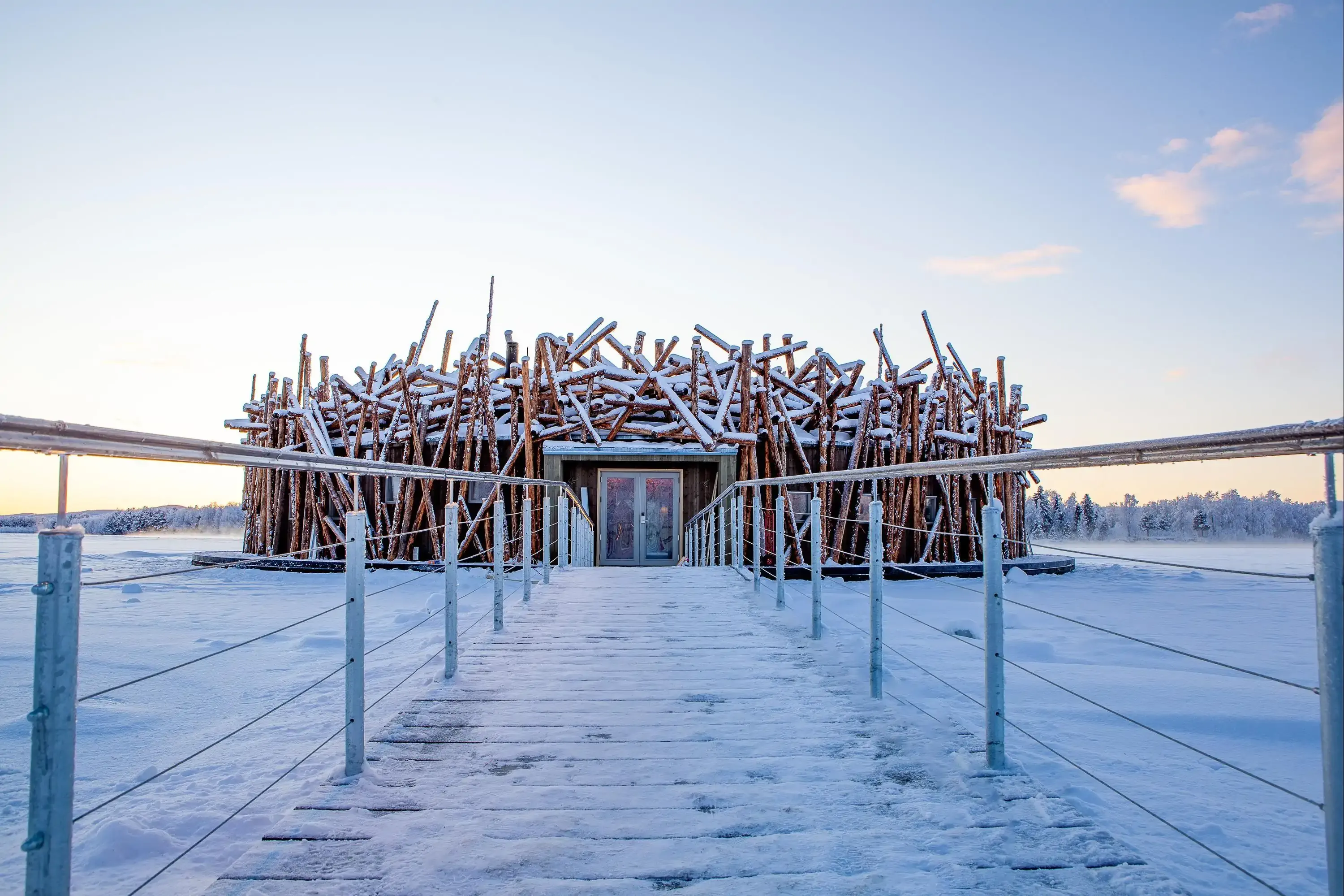 A wooden structure of a hotel covered in snow