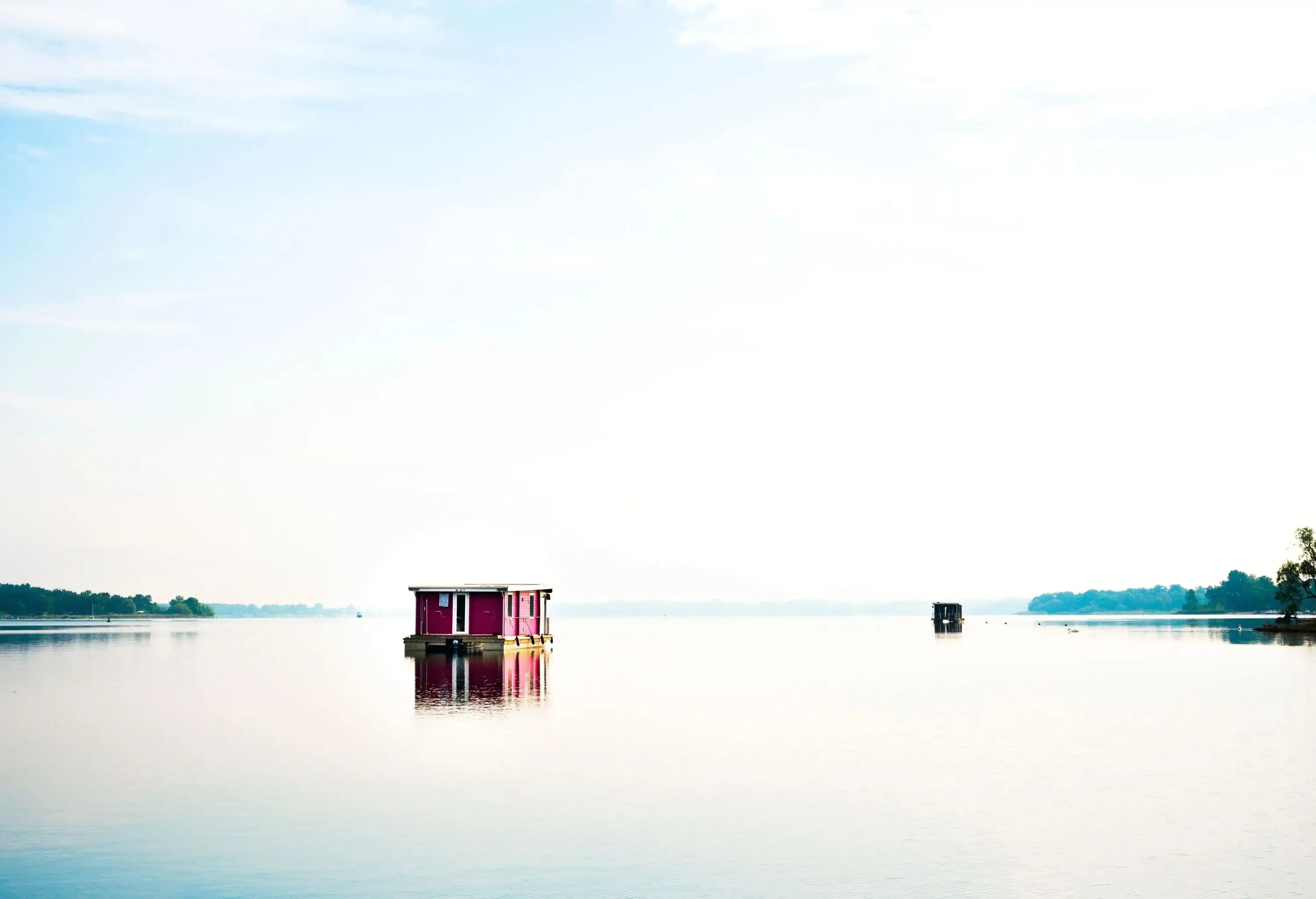 Red houseboat on lake