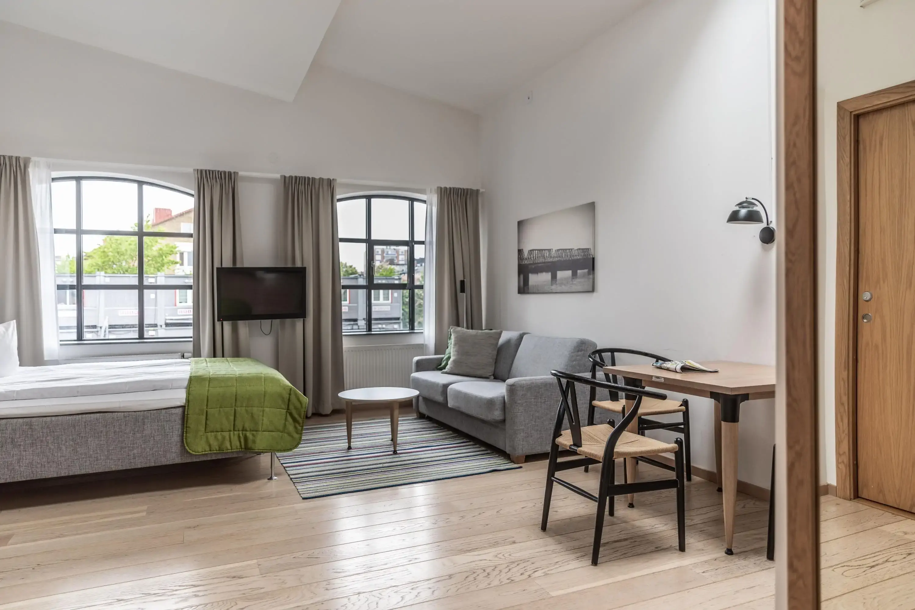 a bright scandinavian hotel room with two big windows