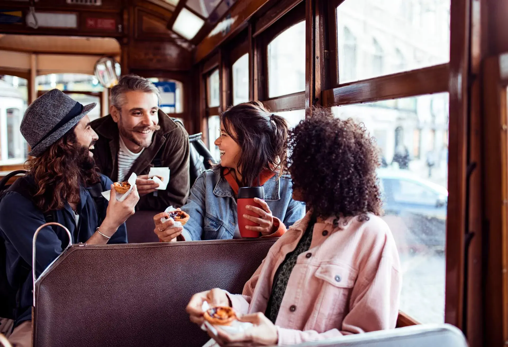 Close up of a group of friends exploring the city with a tram.