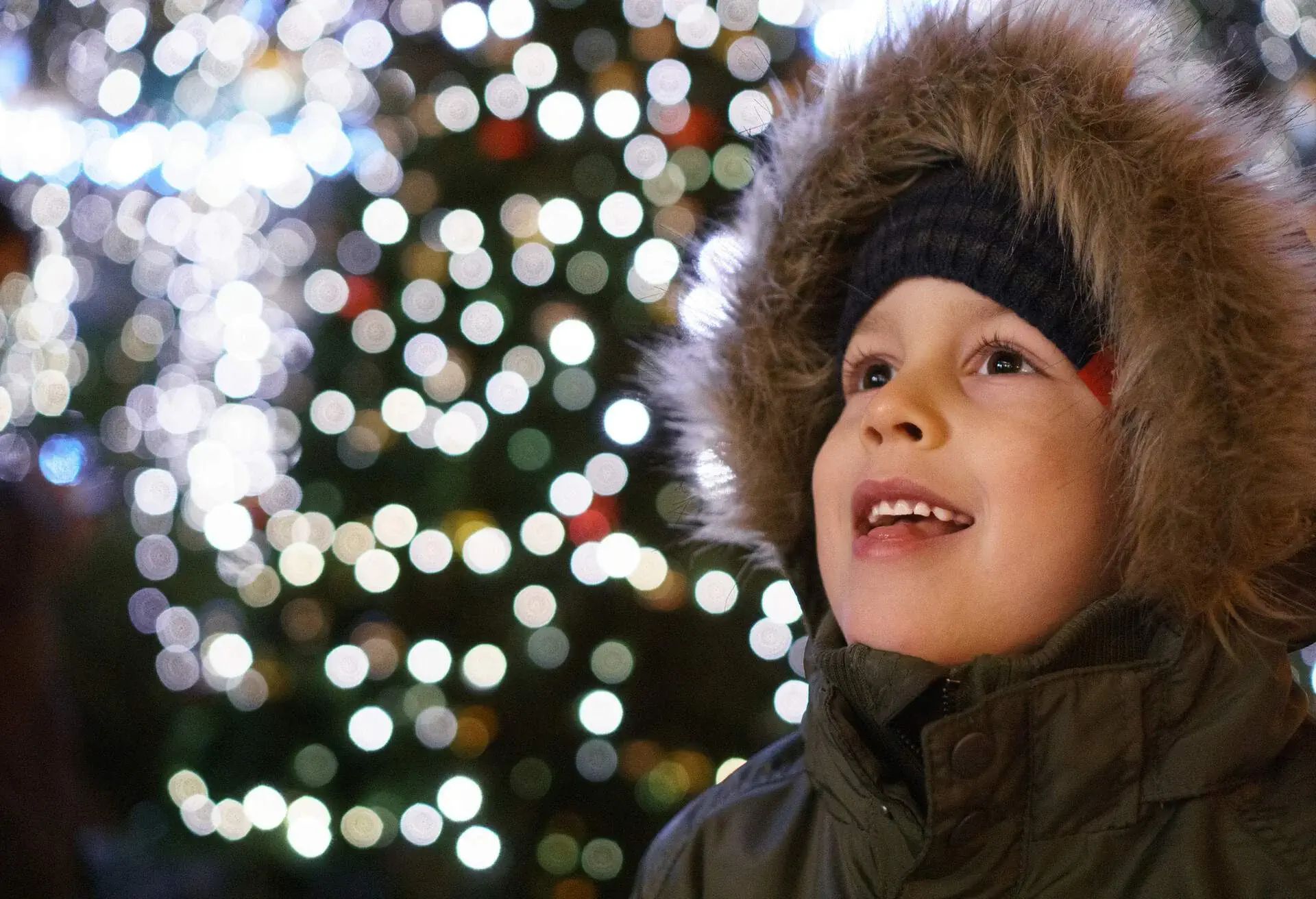 A little boy enjoys the Christmas market environment in Prague.