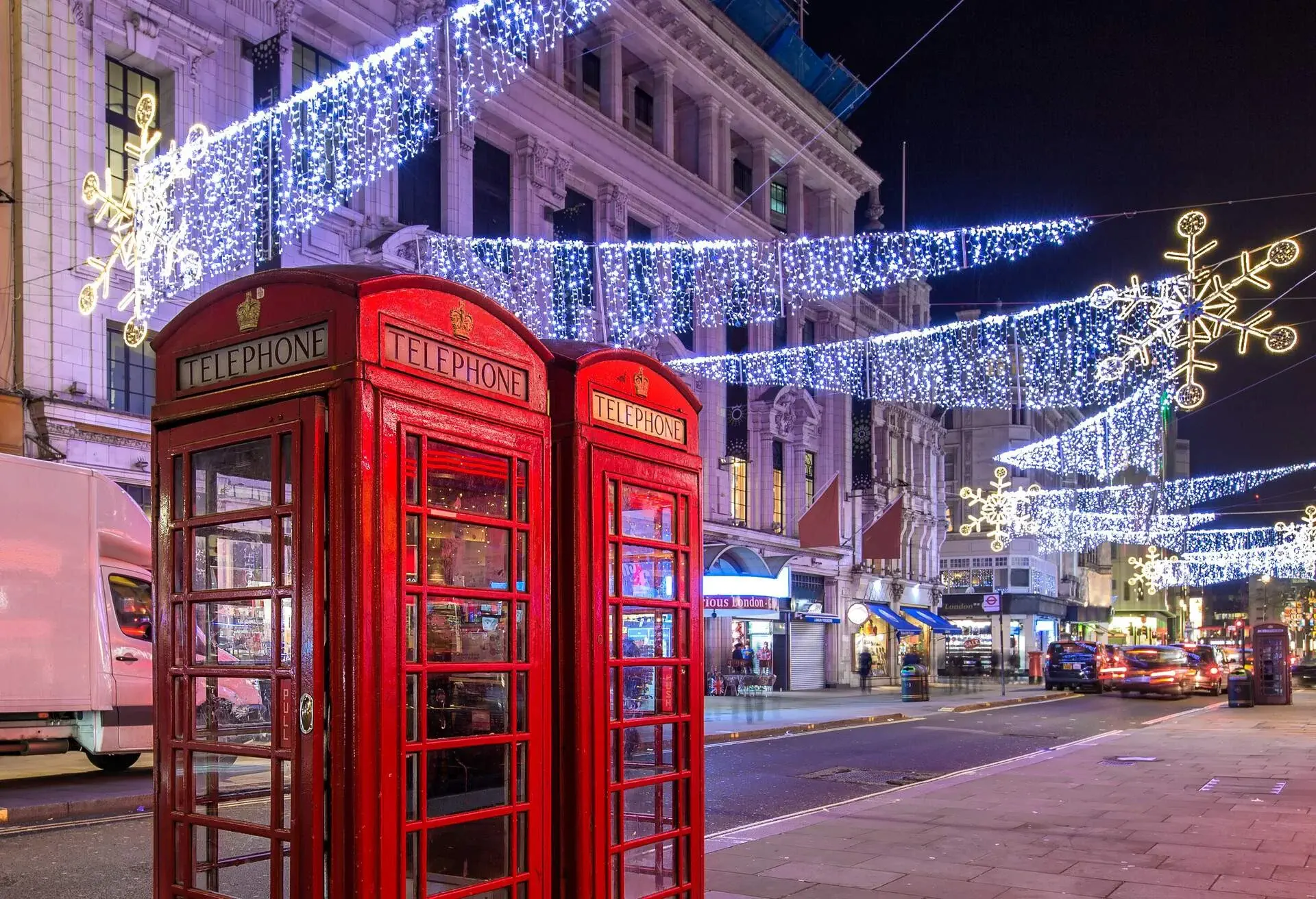 Christmas light in London by red telephone boxes