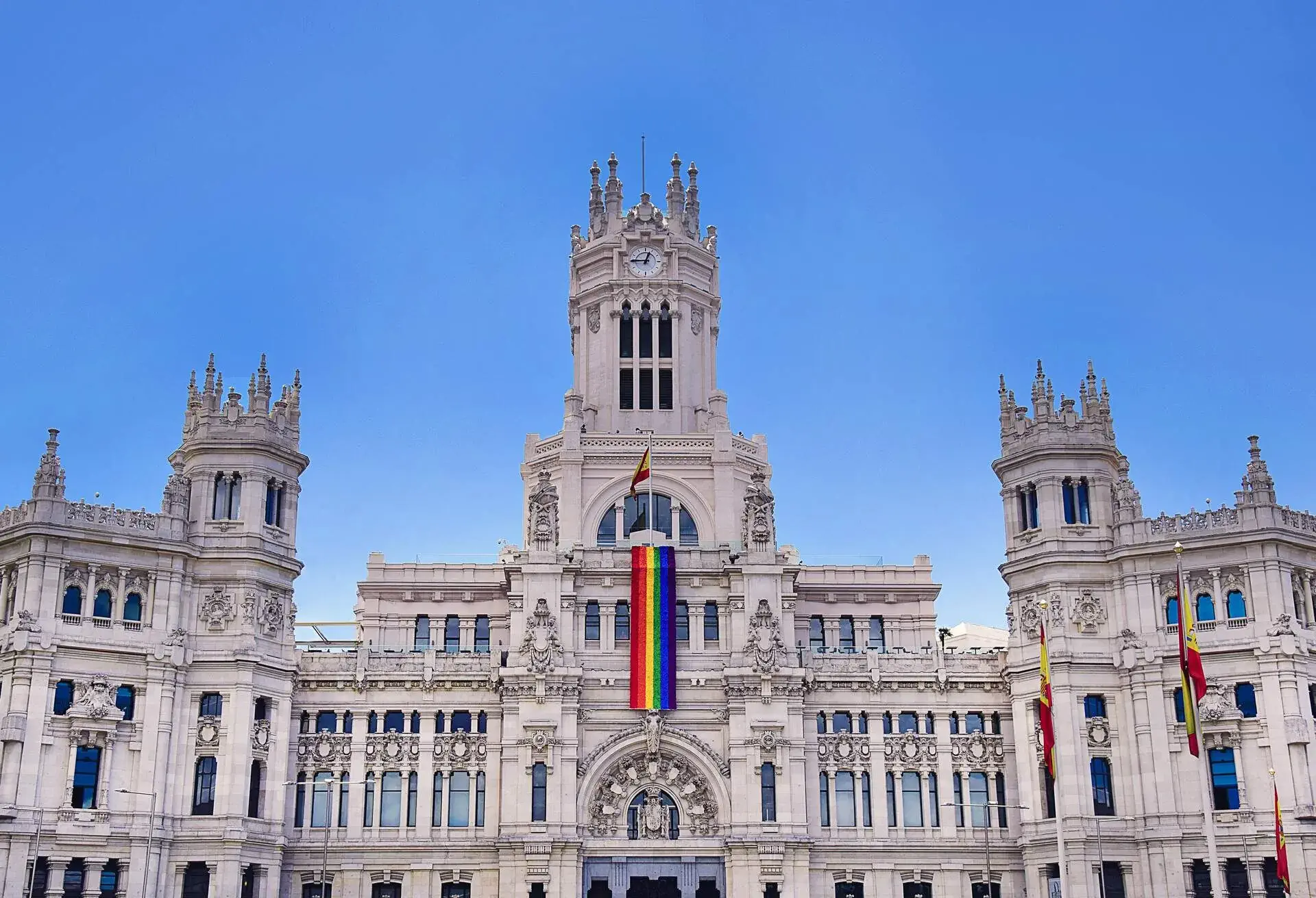A pride flag draped down the center of Madrid's city hall, Spain