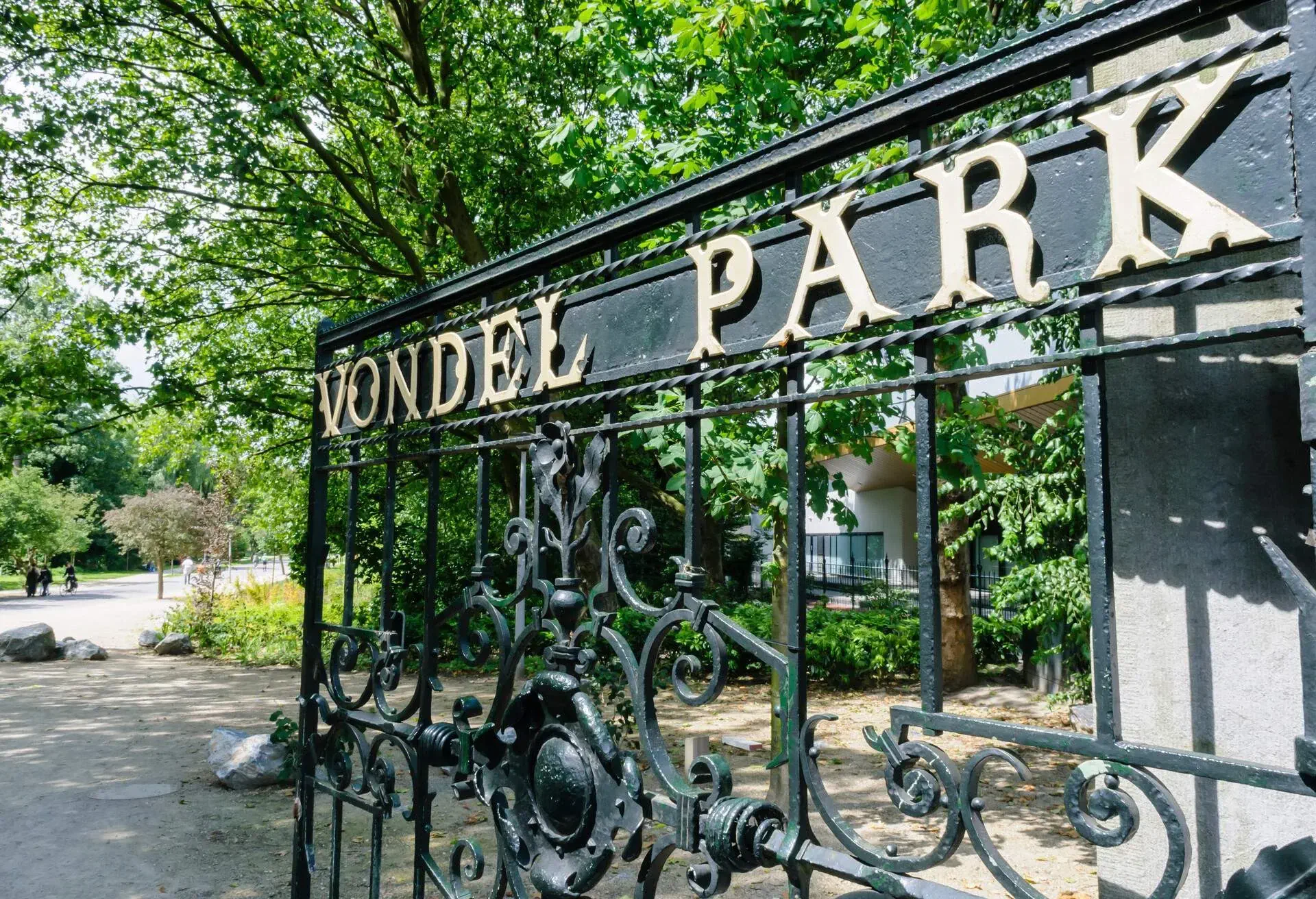 A wrought iron gate with letters that spell VONDEL PARK on it.