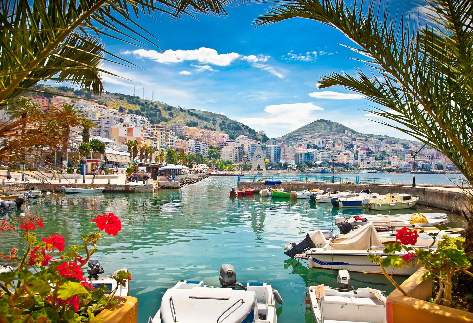View of port town with boats and promenade