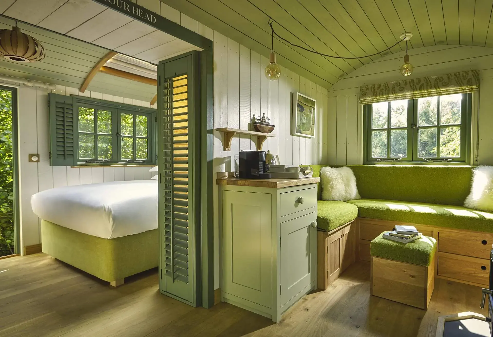 A green hotel suite in a treehouse