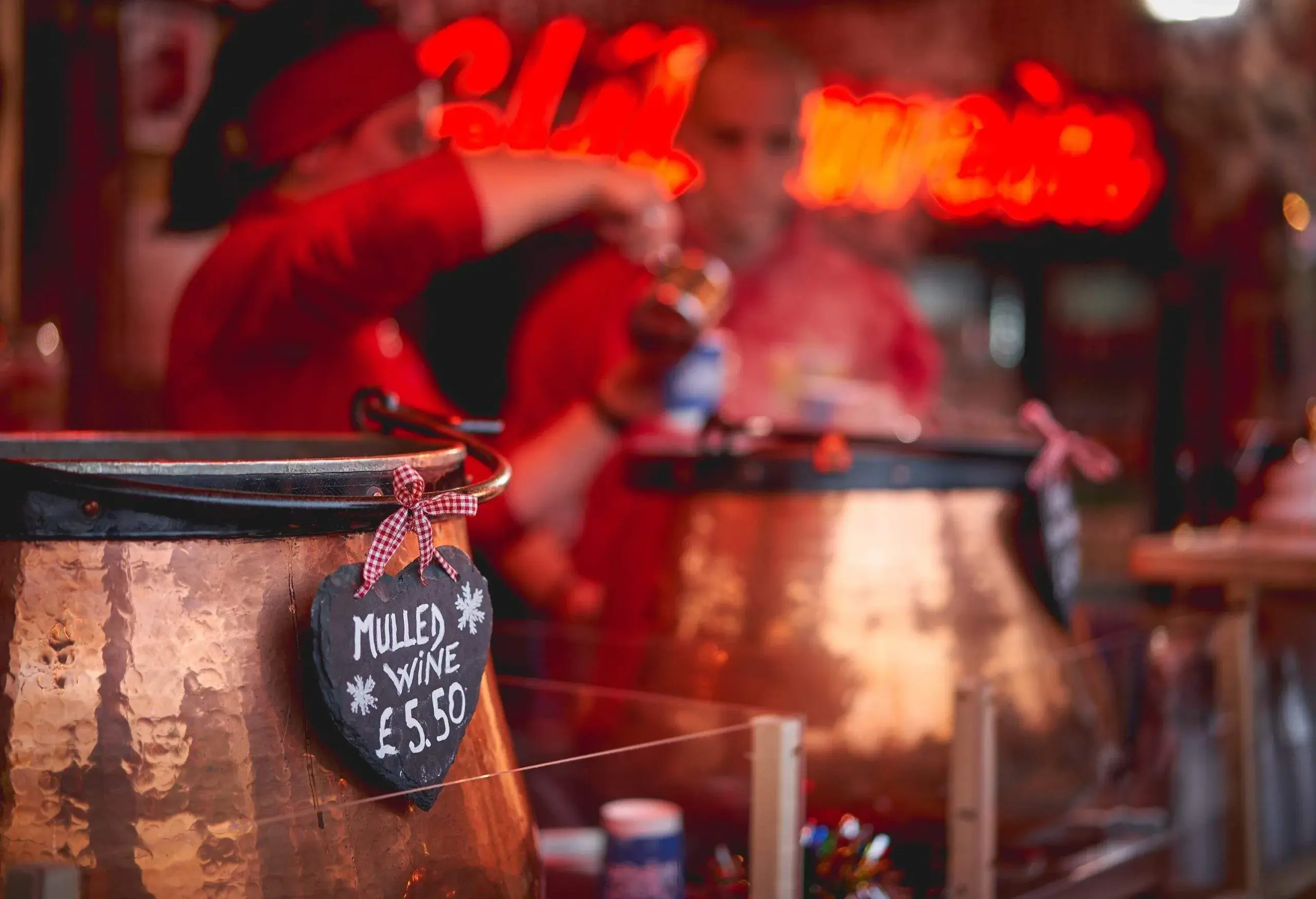 Pots of mulled wine in a stall in a Christmas market.  