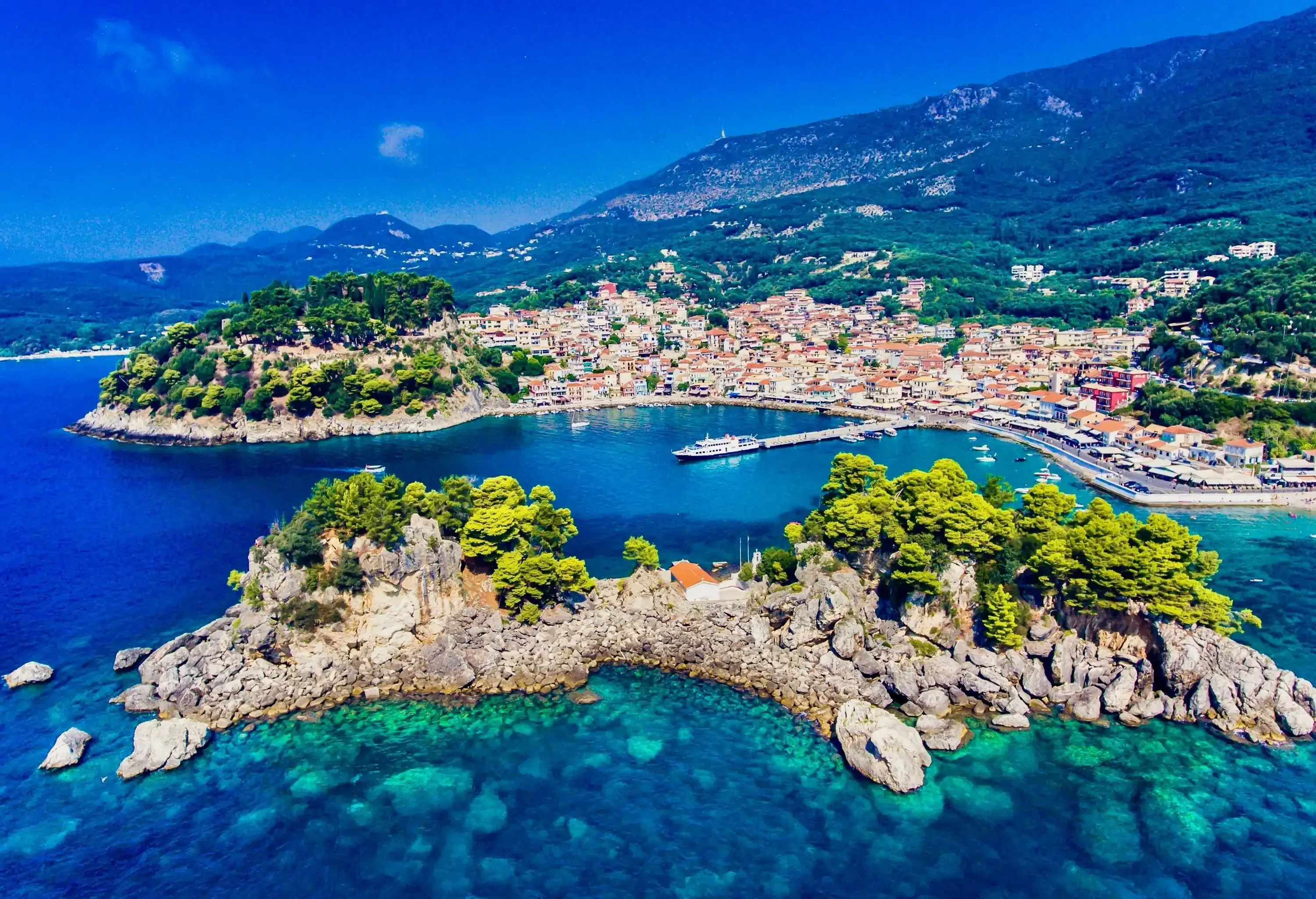 The Panagia Island and the touristic town of Parga surrounded by azure seas.