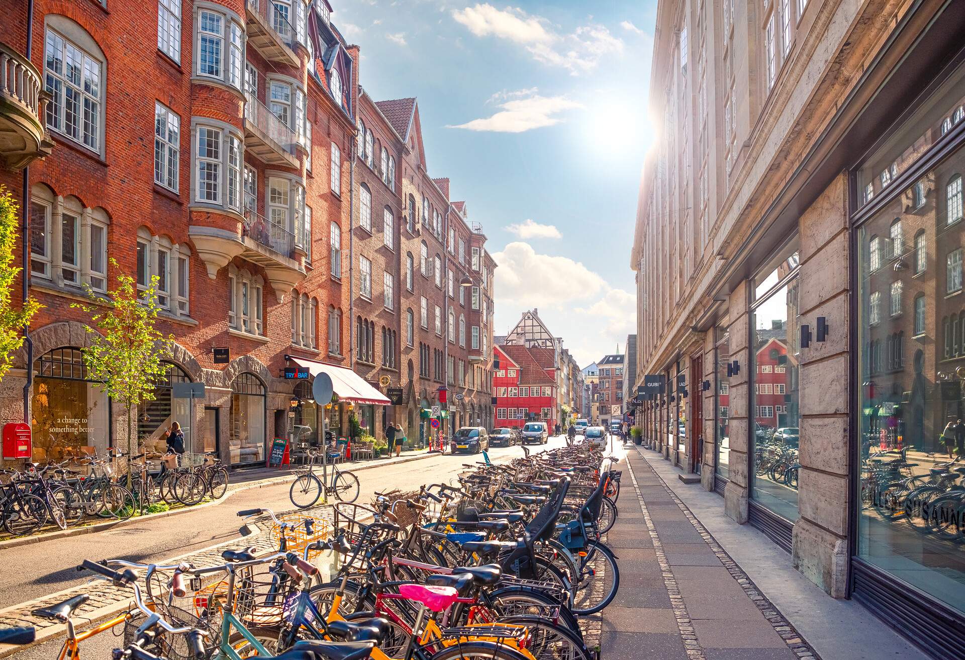 Many parked bikes on a narrow old Minter Street Møntergade in the Old Town of Copenhagen, Denmark
