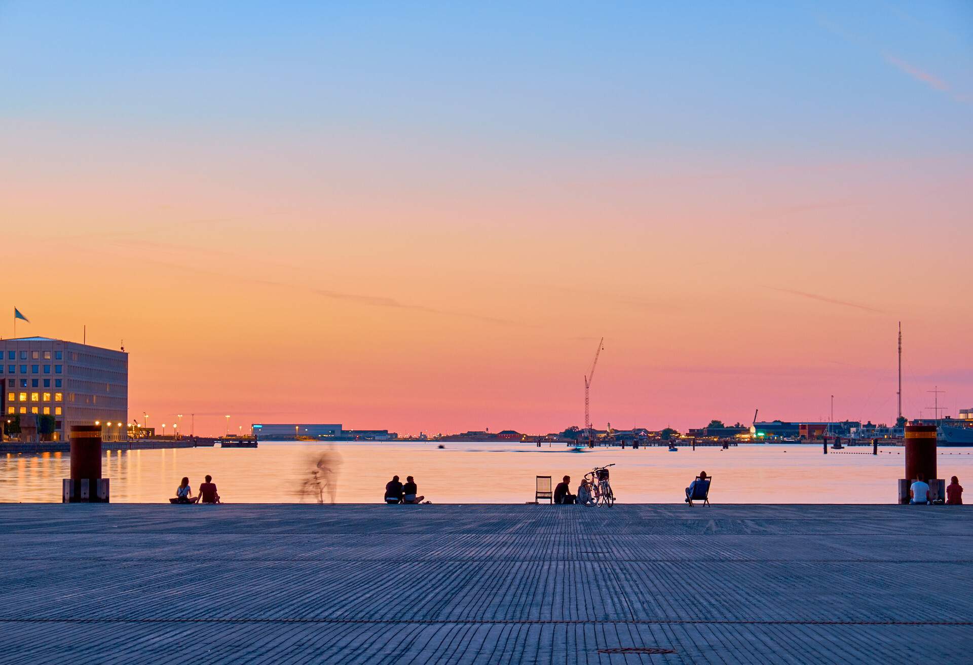 Cityscape at night. People on the beach enjoy the sunset in the center of Copenhagen.