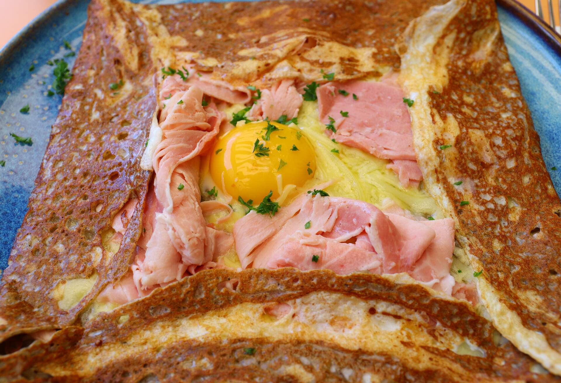 A classic French crêpe filled with ham and cheese, topped by a sunnyside-up egg.