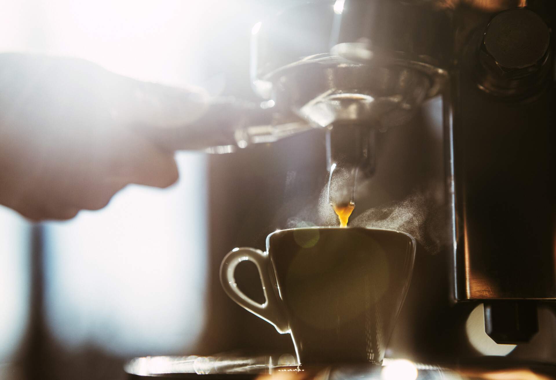 Woman making espresso coffee.