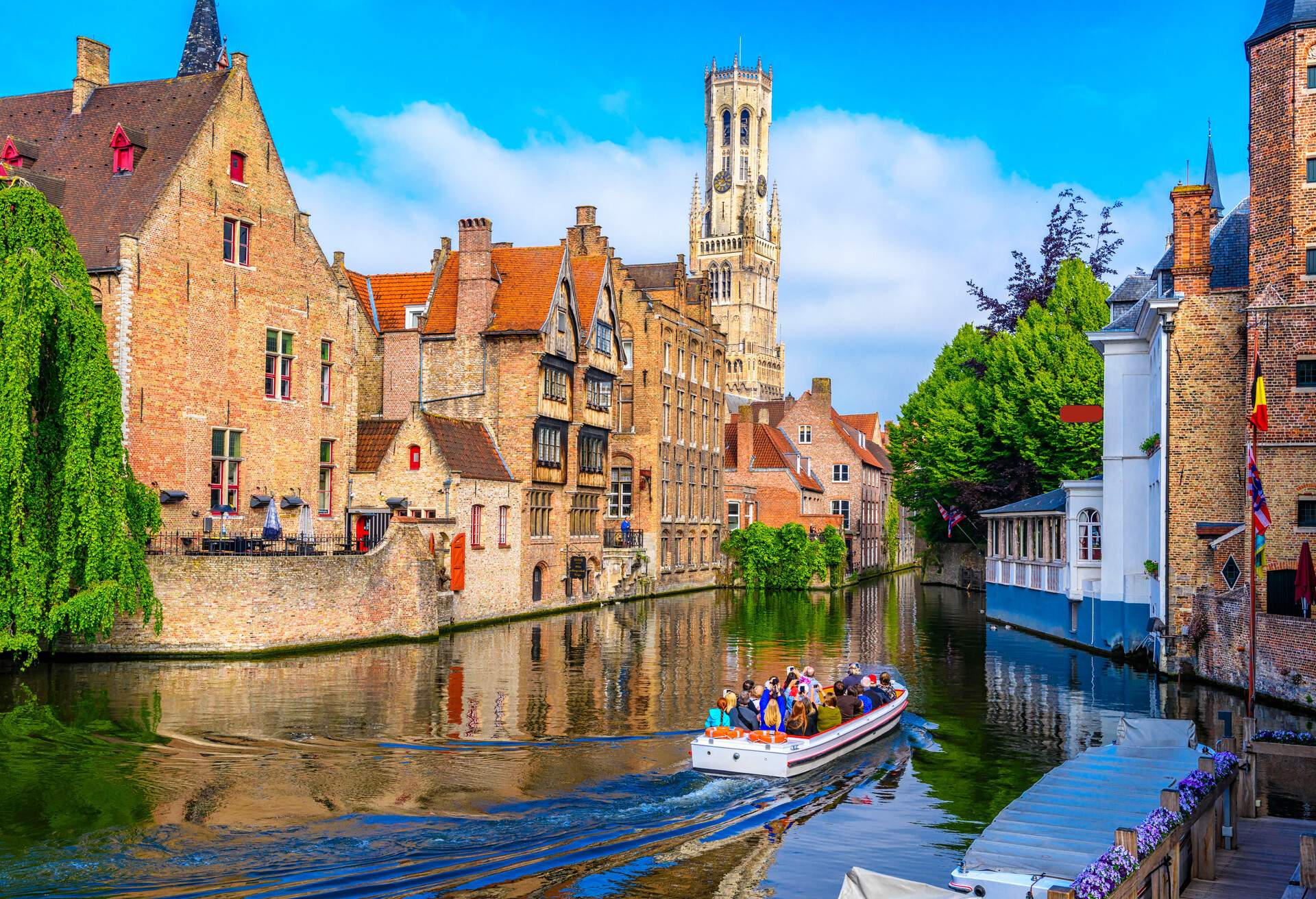 A group of people taking a boat tour of the city's monumental architecture.