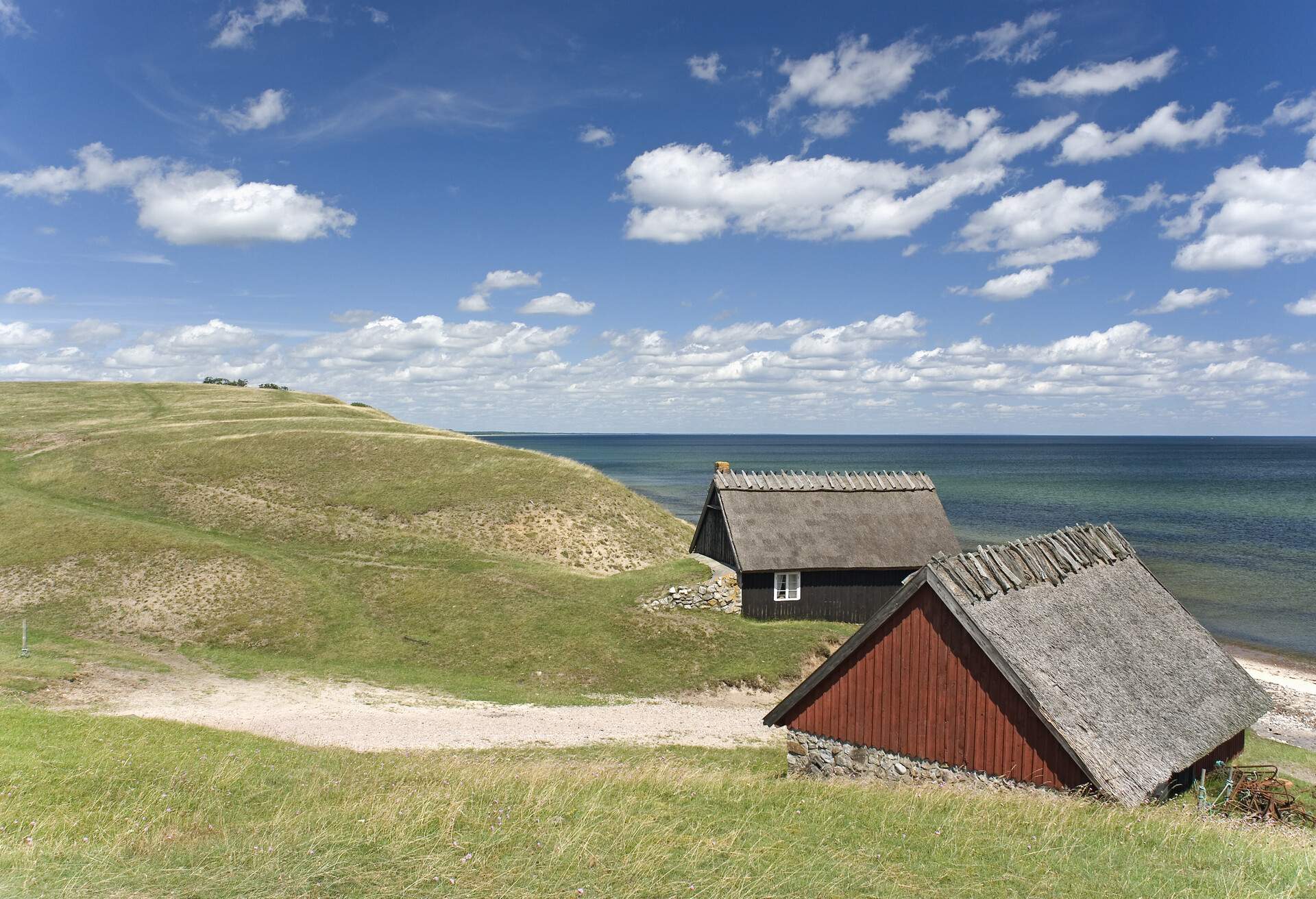 Two traditional small houses on a hill overlooking the sea in Osterlen, Sweden