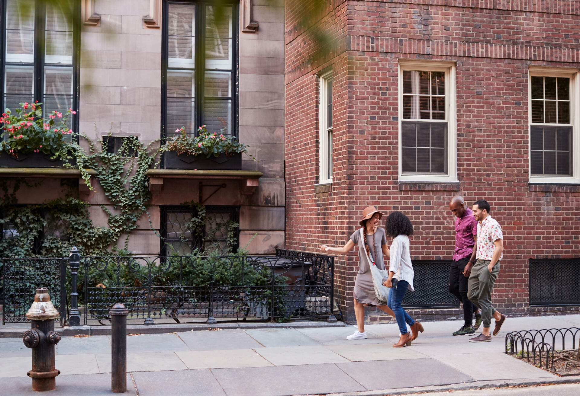 Group Of Friends Walking Along Urban Street In New York City, USA