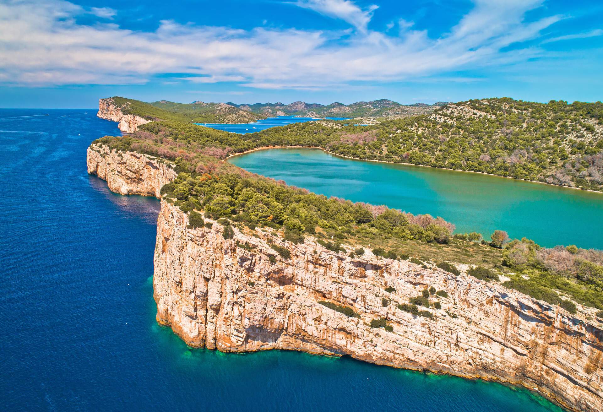 Telascica nature park cliffs and green Mir lake on Dugi Otok island aerial view, Kornati archipelago national park of Croatia