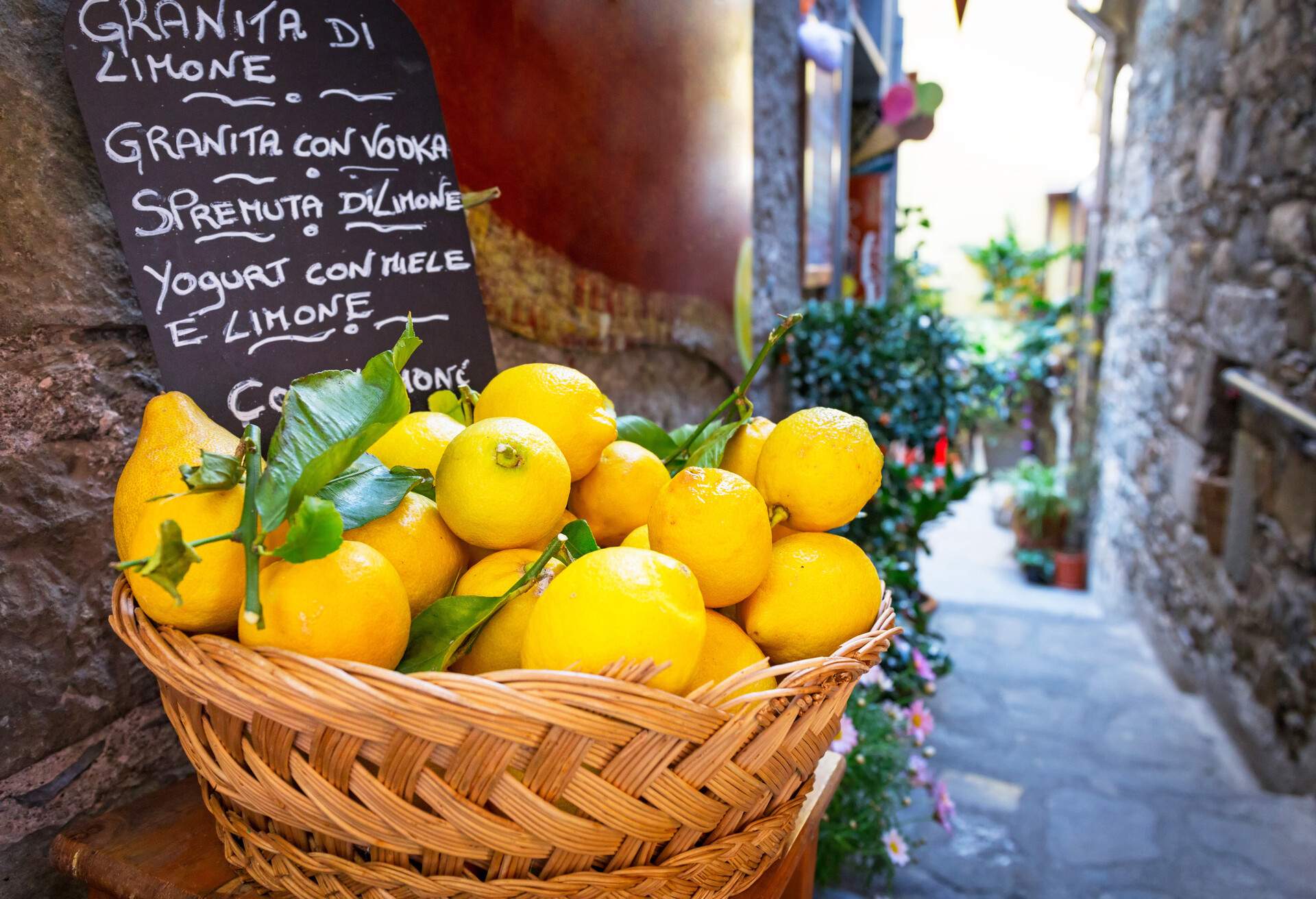 Wicker basket full of lemons on the italian street od Corniglia