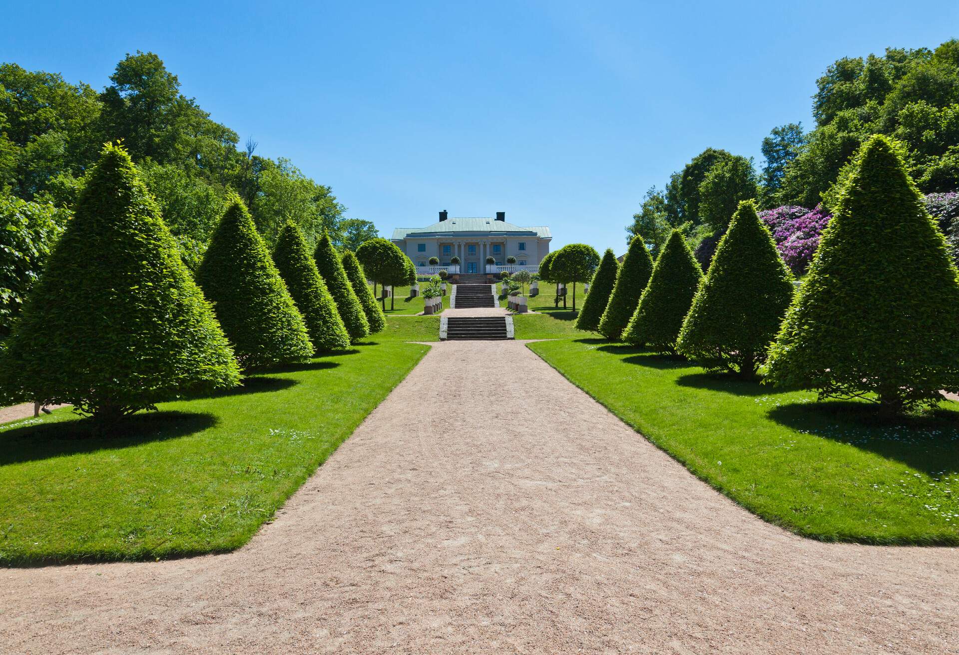 Gunnebo Castle garden in Mondal, Sweden. with trimmed trees along the garden path