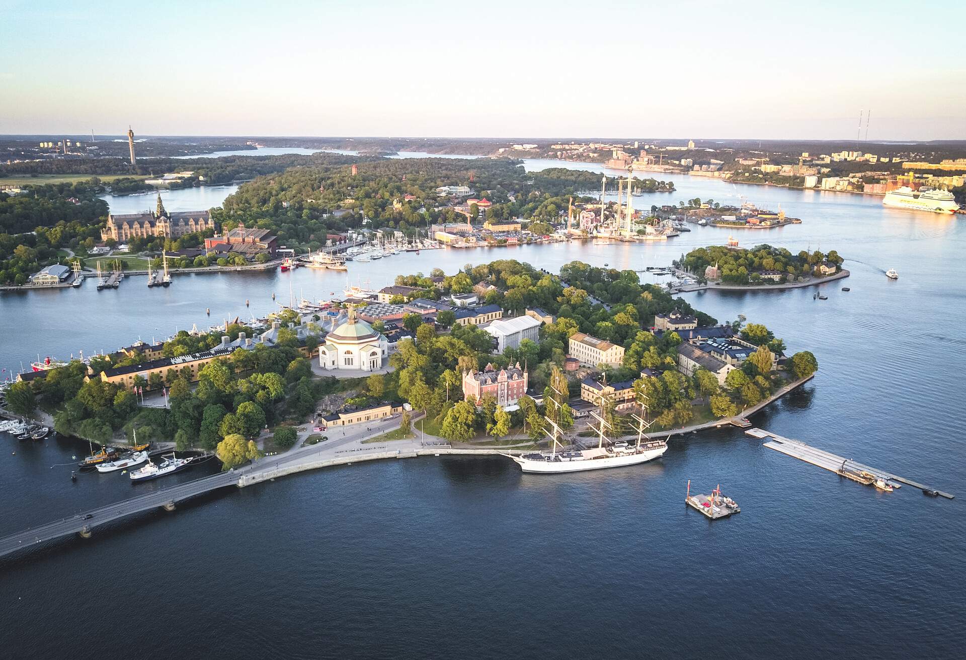 Aerial drone view of Stockholm urban skyline, with surrounding islands cityscape of Skeppsholmen, Kastellholmen and Djurgarden at sunset, central Stockholm, capital city of Sweden.