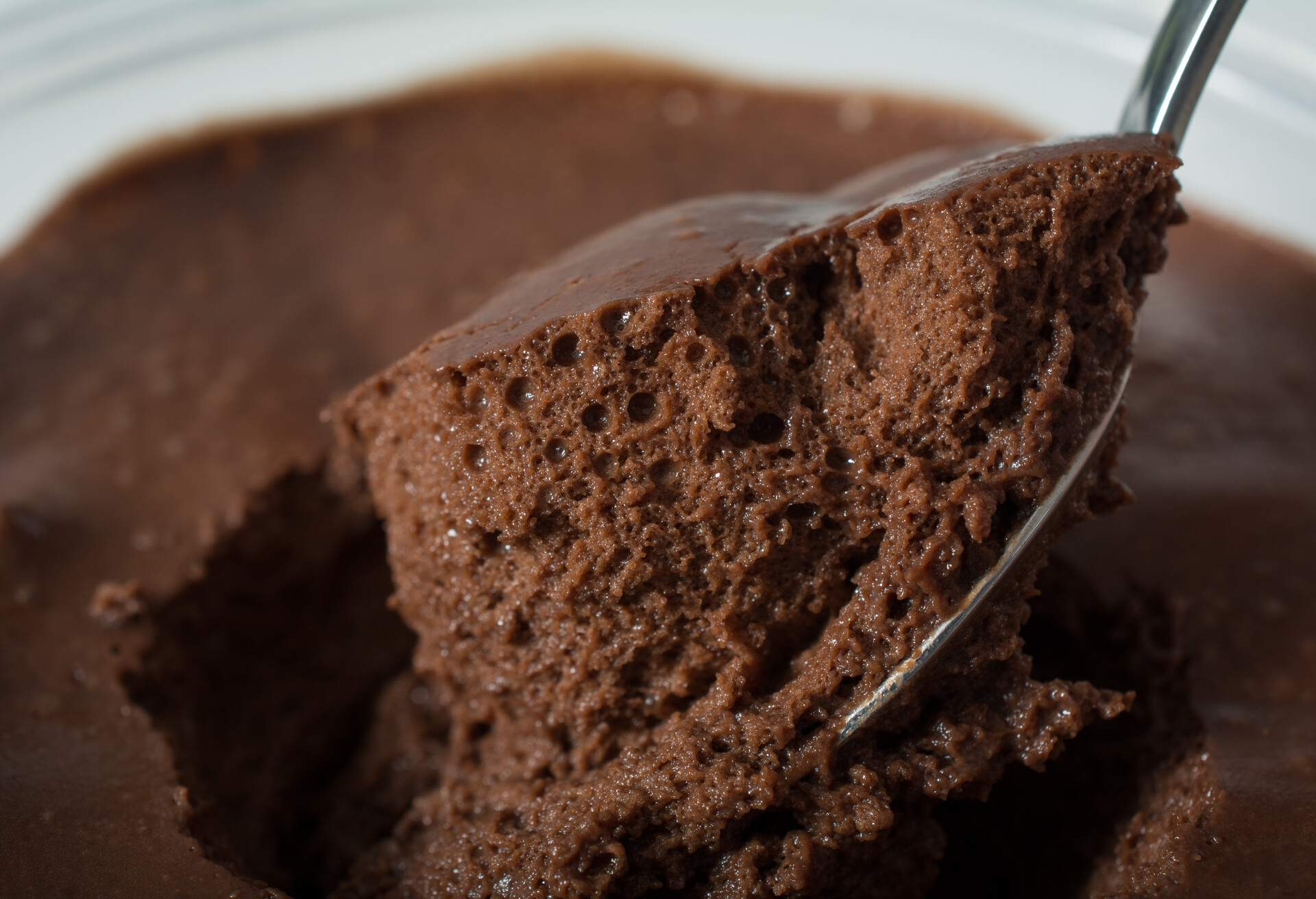 Close up Very dark chocolate mousse on a spoon ready to eat