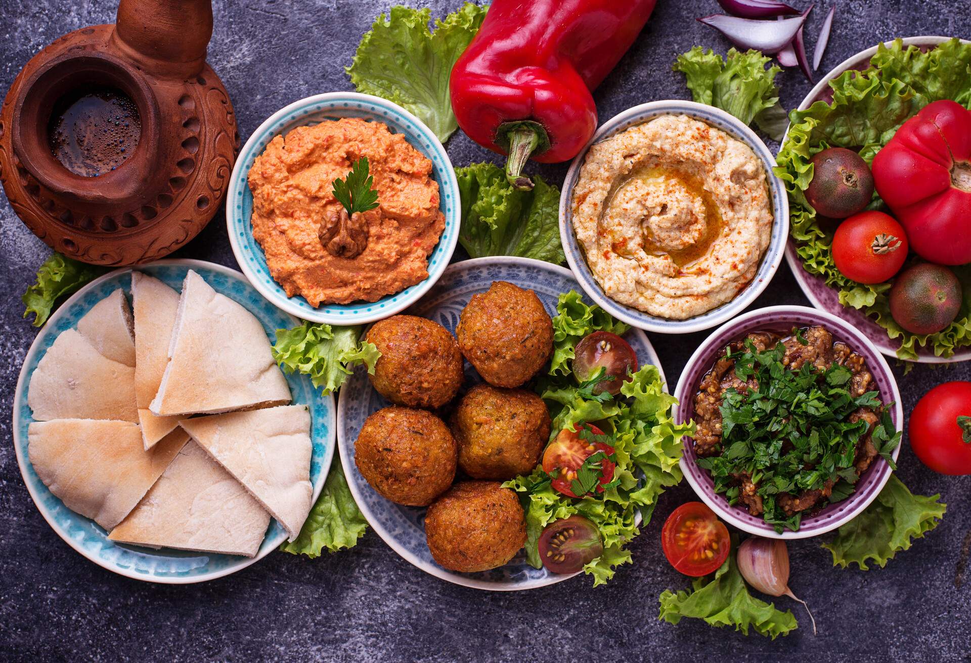 Selection of Middle eastern or Arabic dishes. Falafel, hummus, pita and  muhammara. Top view