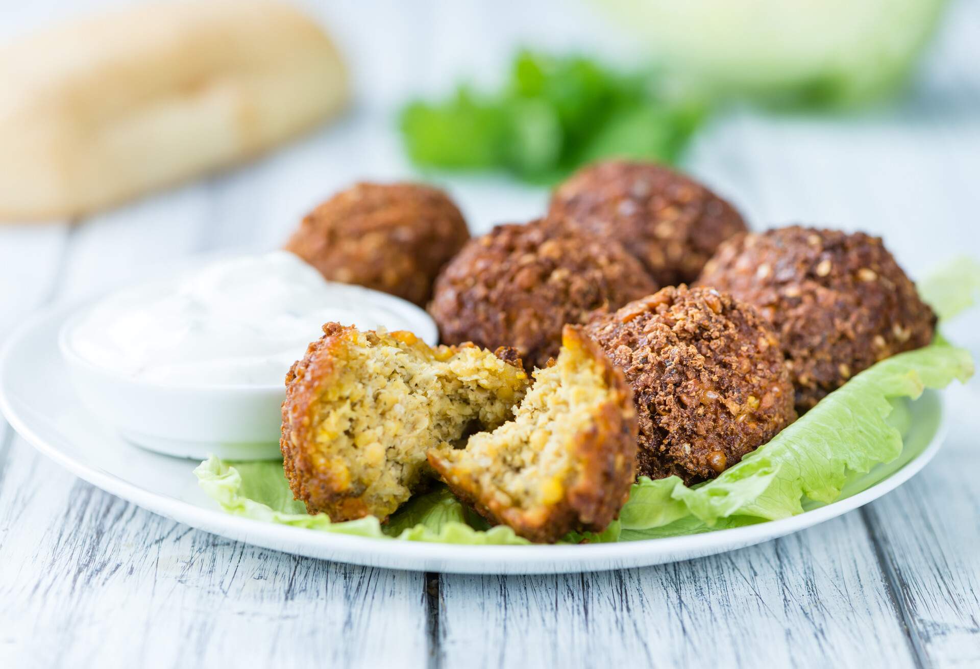 Wooden table with Falafels (close-up shot; selective focus)