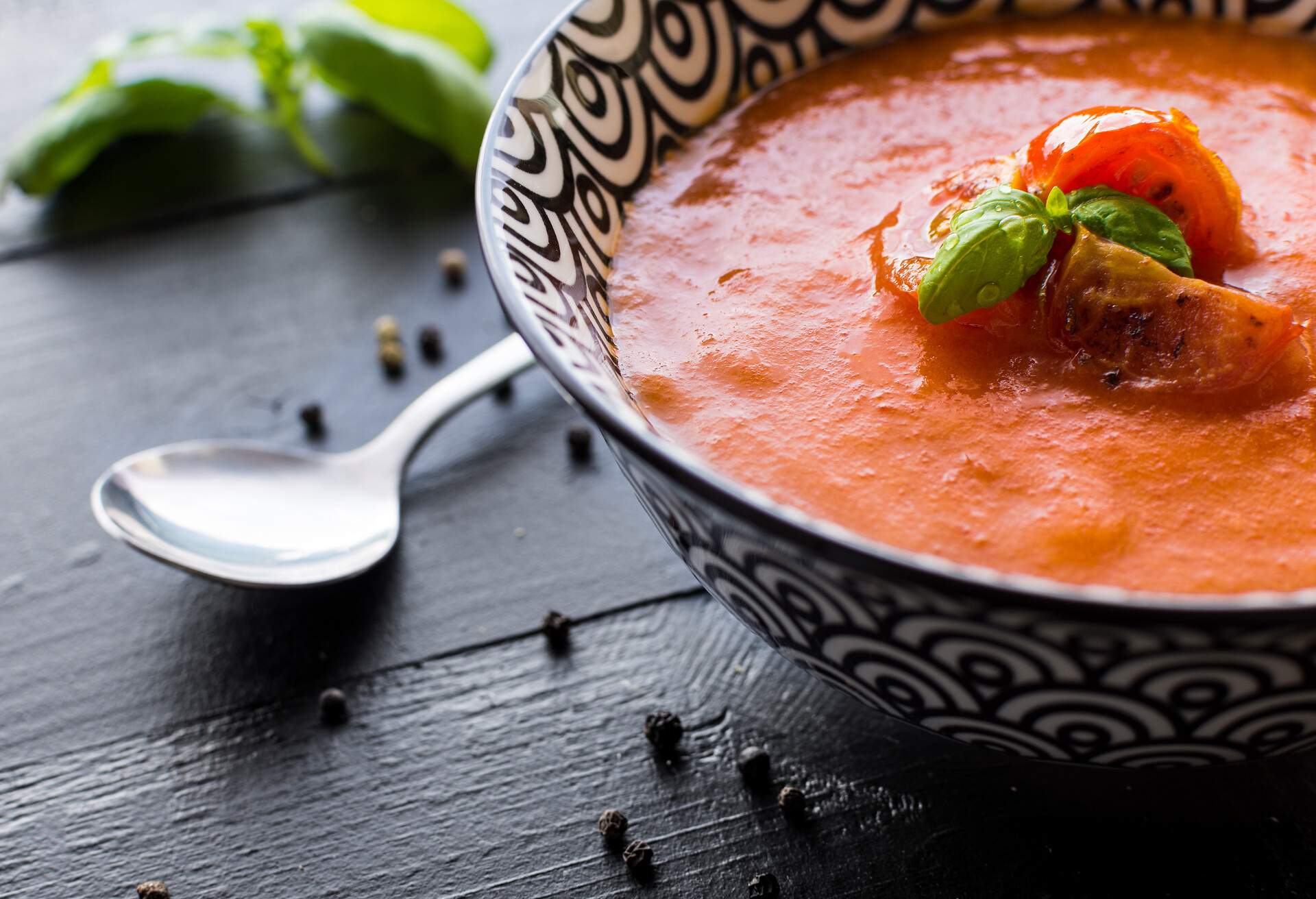 Vegetarian Tomato Soup on Dark Wooden Background