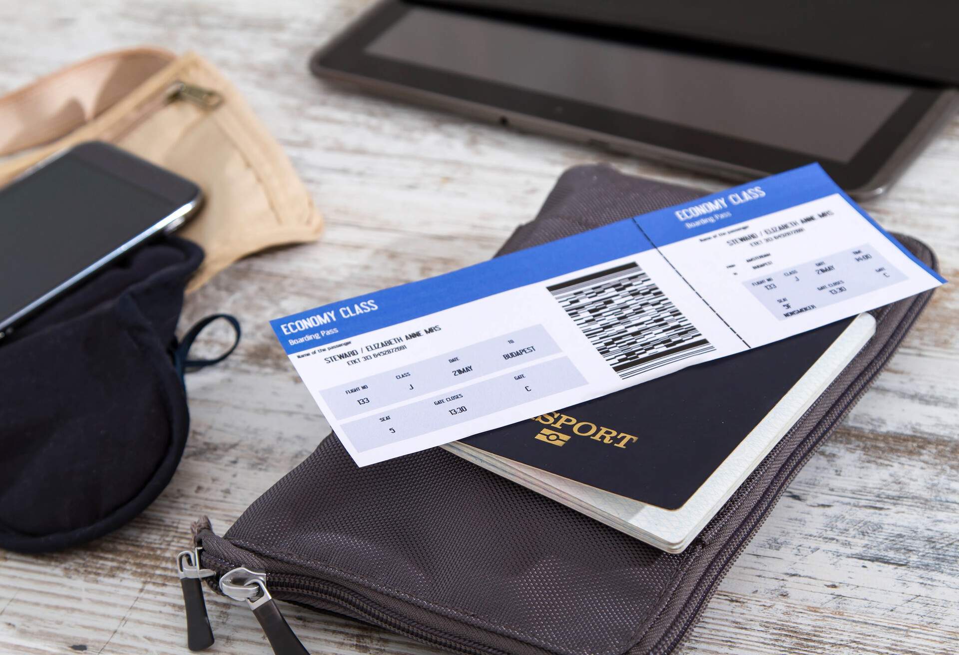 Airline ticket, passport and electronics, preparing to travel
