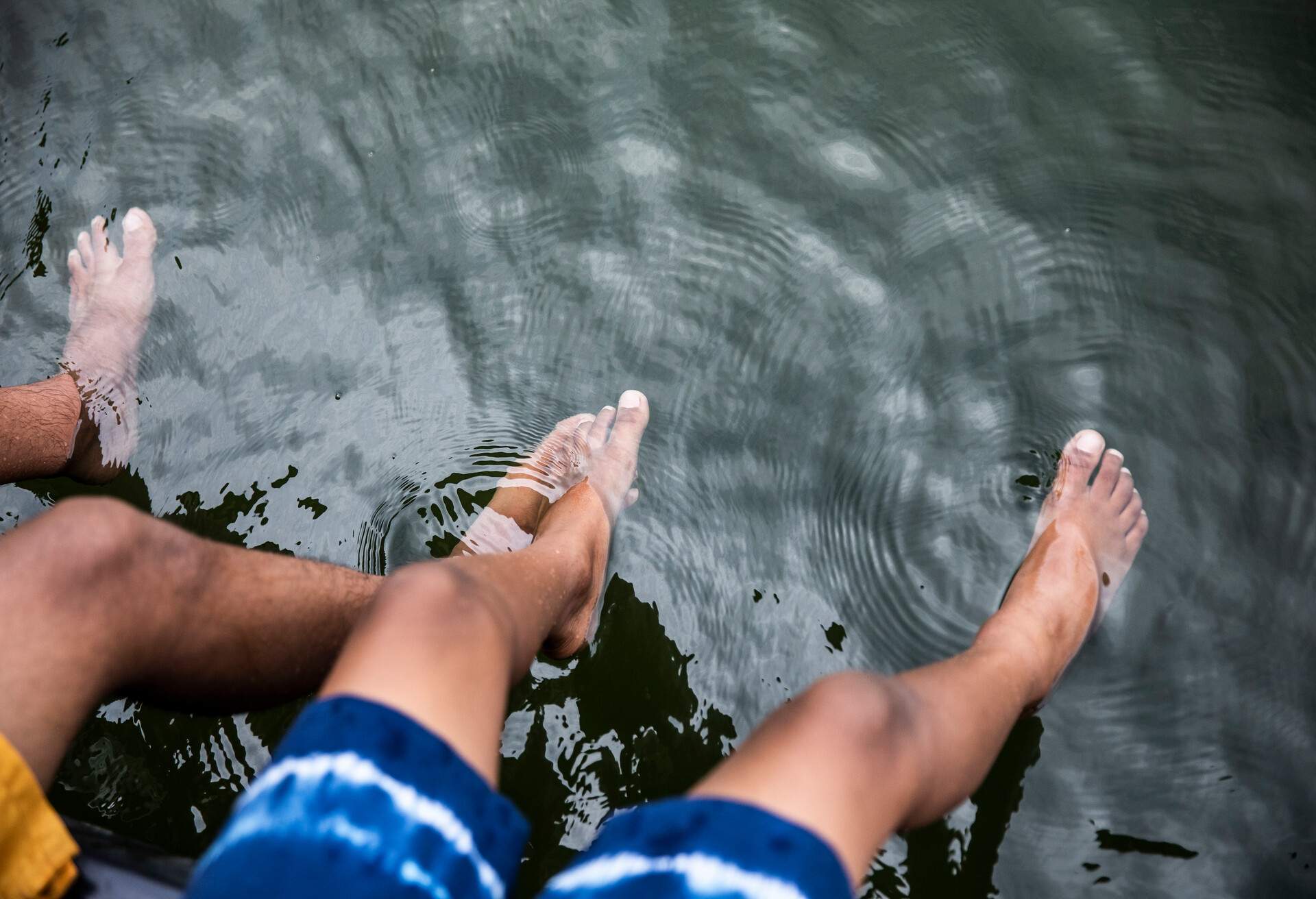 Young boys splashing water at lake