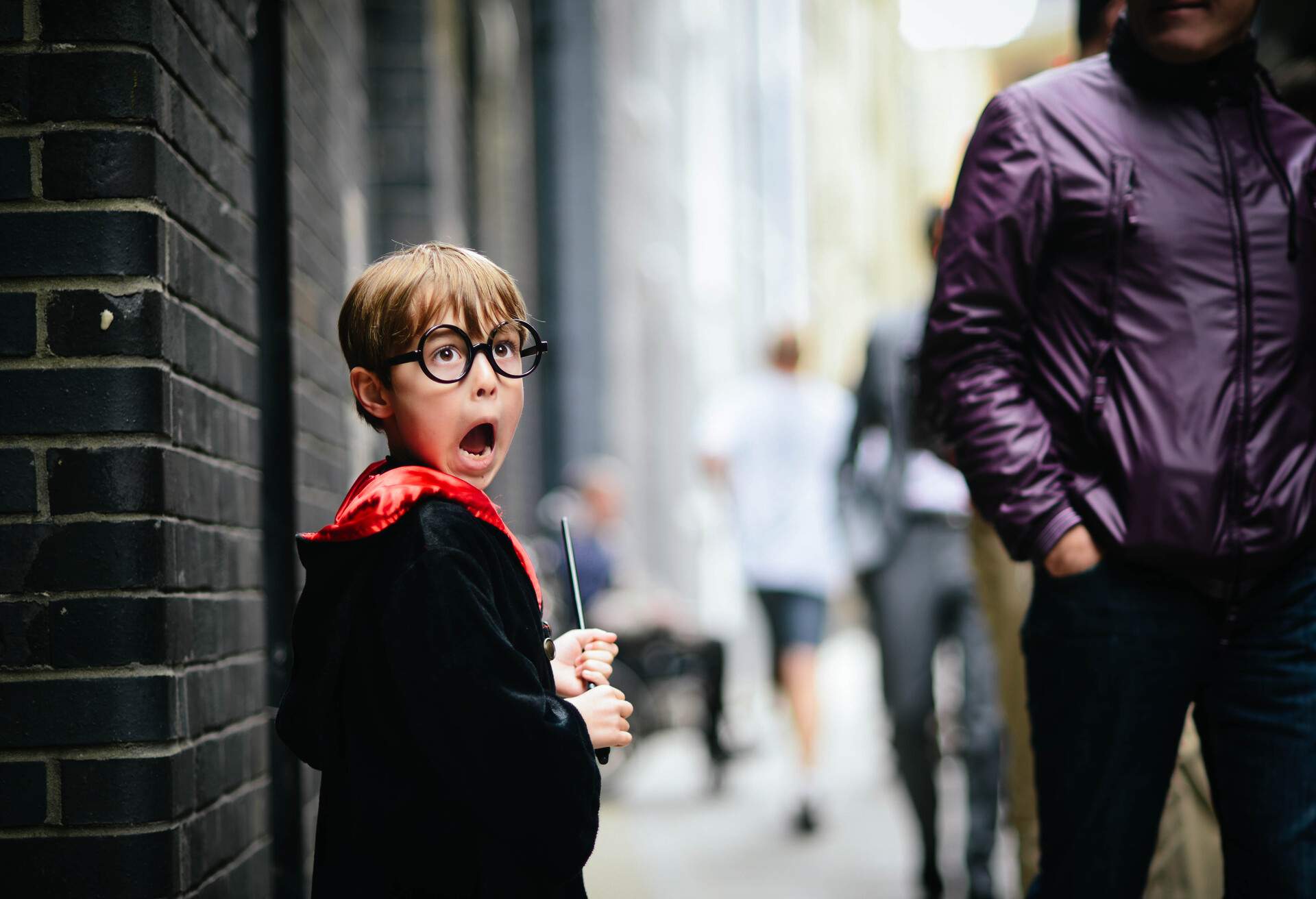 Boy, pretending to be Harry Potter. He is carrying a wand and has his mouth wide open as he pretends to see a Dementor.