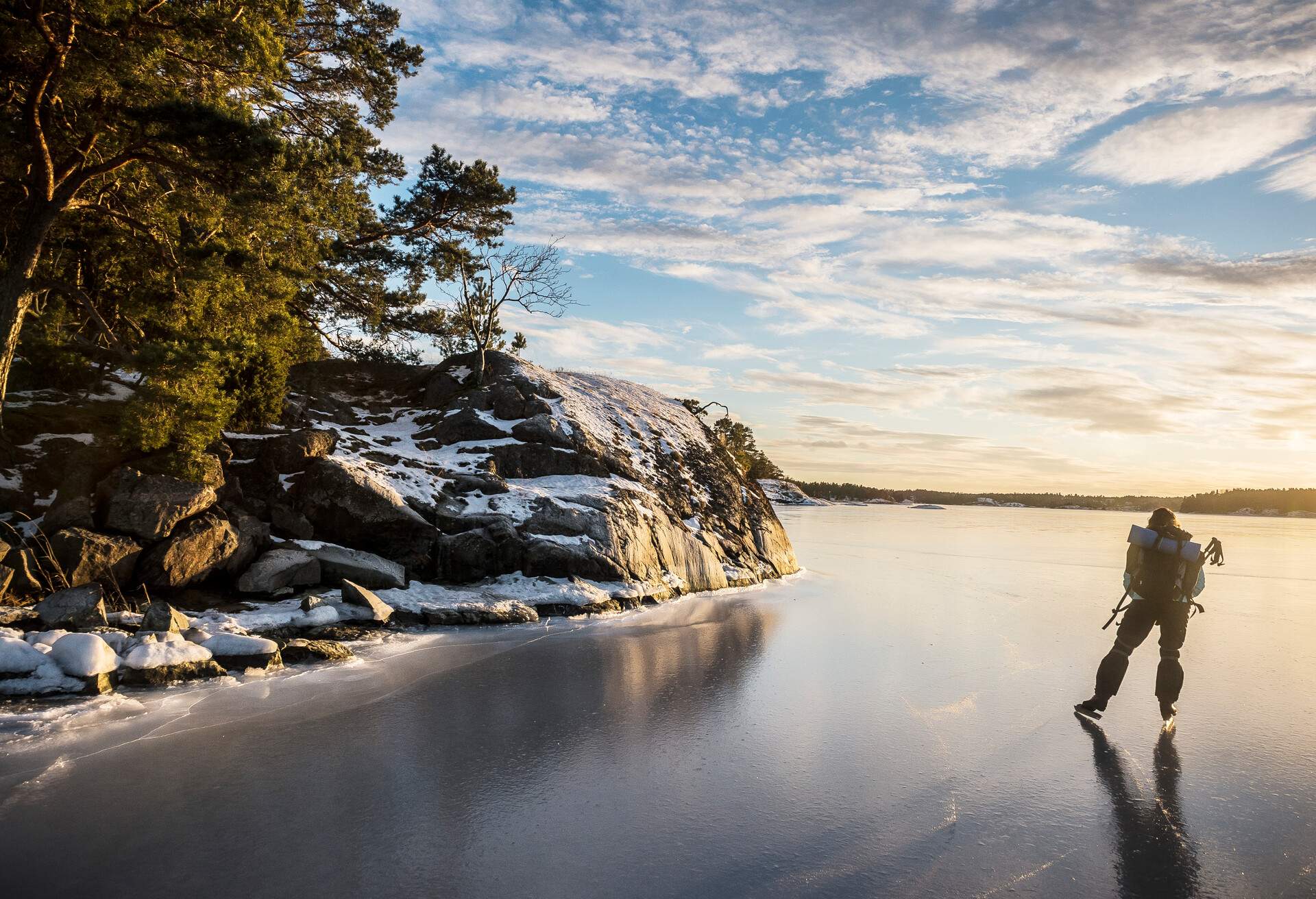 A person ice skating in a frozen lake 