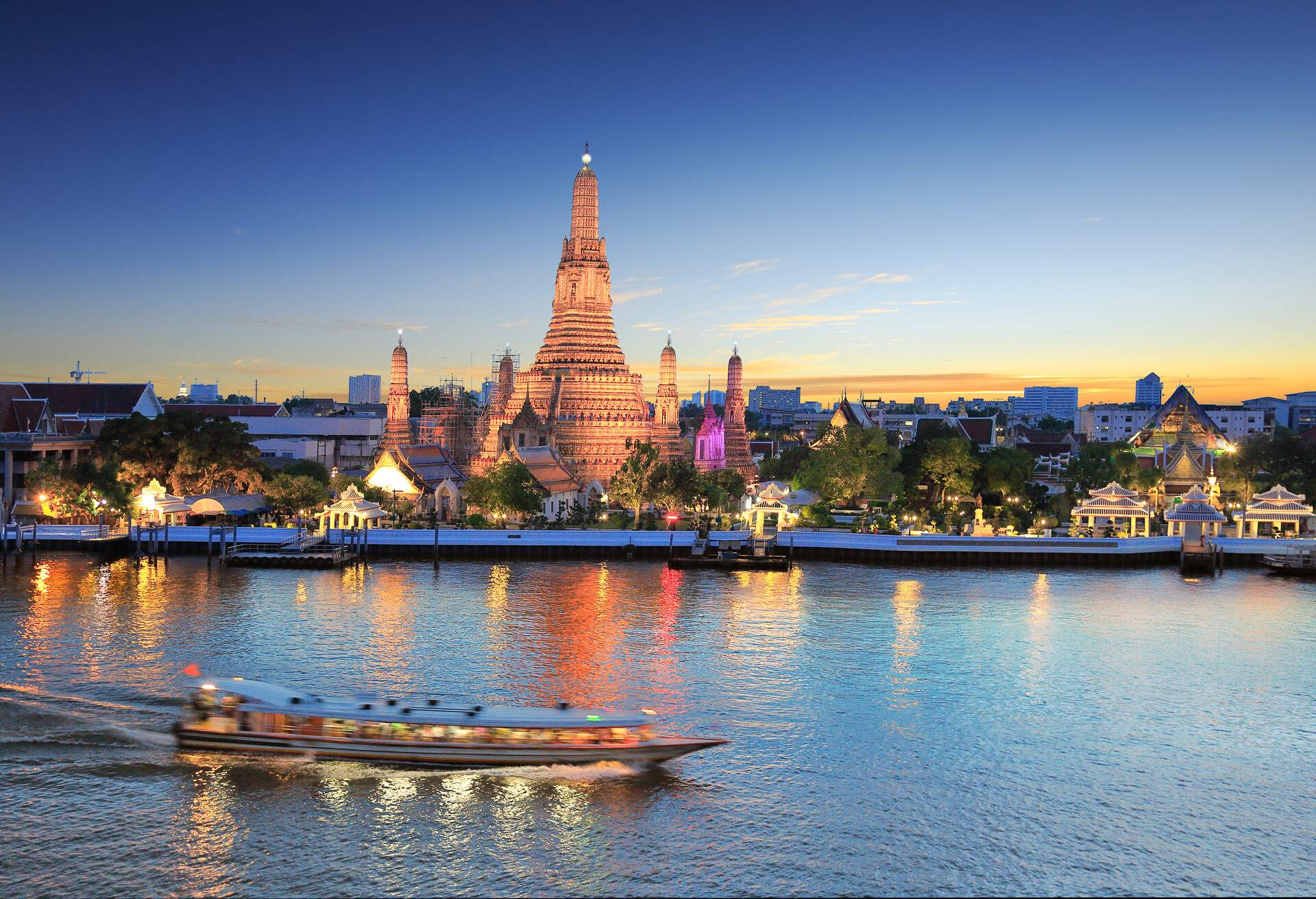 Wat Arun and cruise ship in twilight time, Bangkok, Thailand, on the Thonburi west bank of the Chao Phraya River.