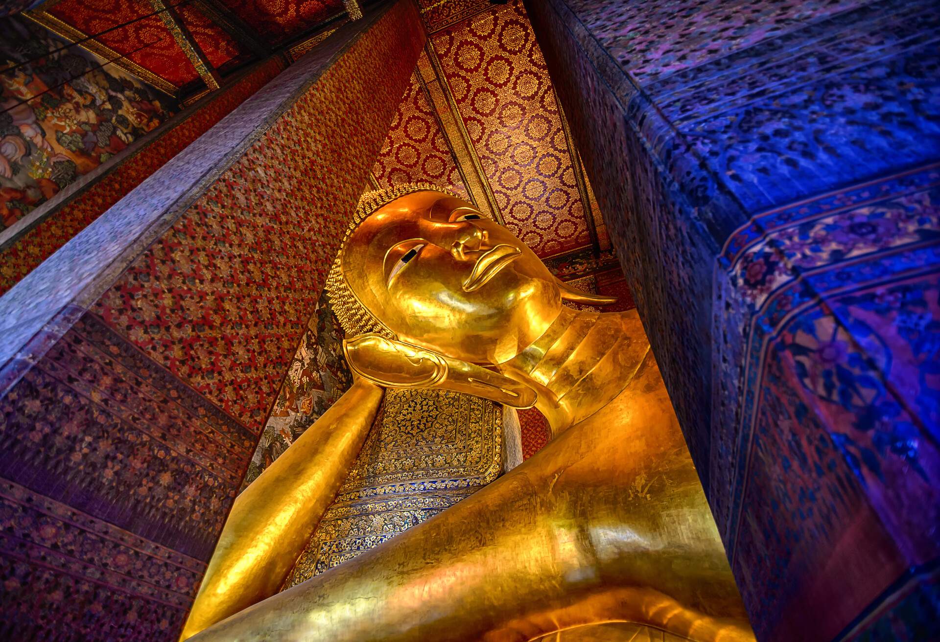 The Reclining Buddha inside the Wat Phra Chetuphon Vimolmangklararm Rajwaramahaviharn in a Buddhist temple complex of Wat Pho in the Phra Nakhon District, Bangkok, Thailand. Built by Rama III in 1832 which represents the entry of Buddha into Nirvana and the end of all reincarnations.The image is 15 meters high and 46 meters long and one of the largest Buddha statue in Thailand.