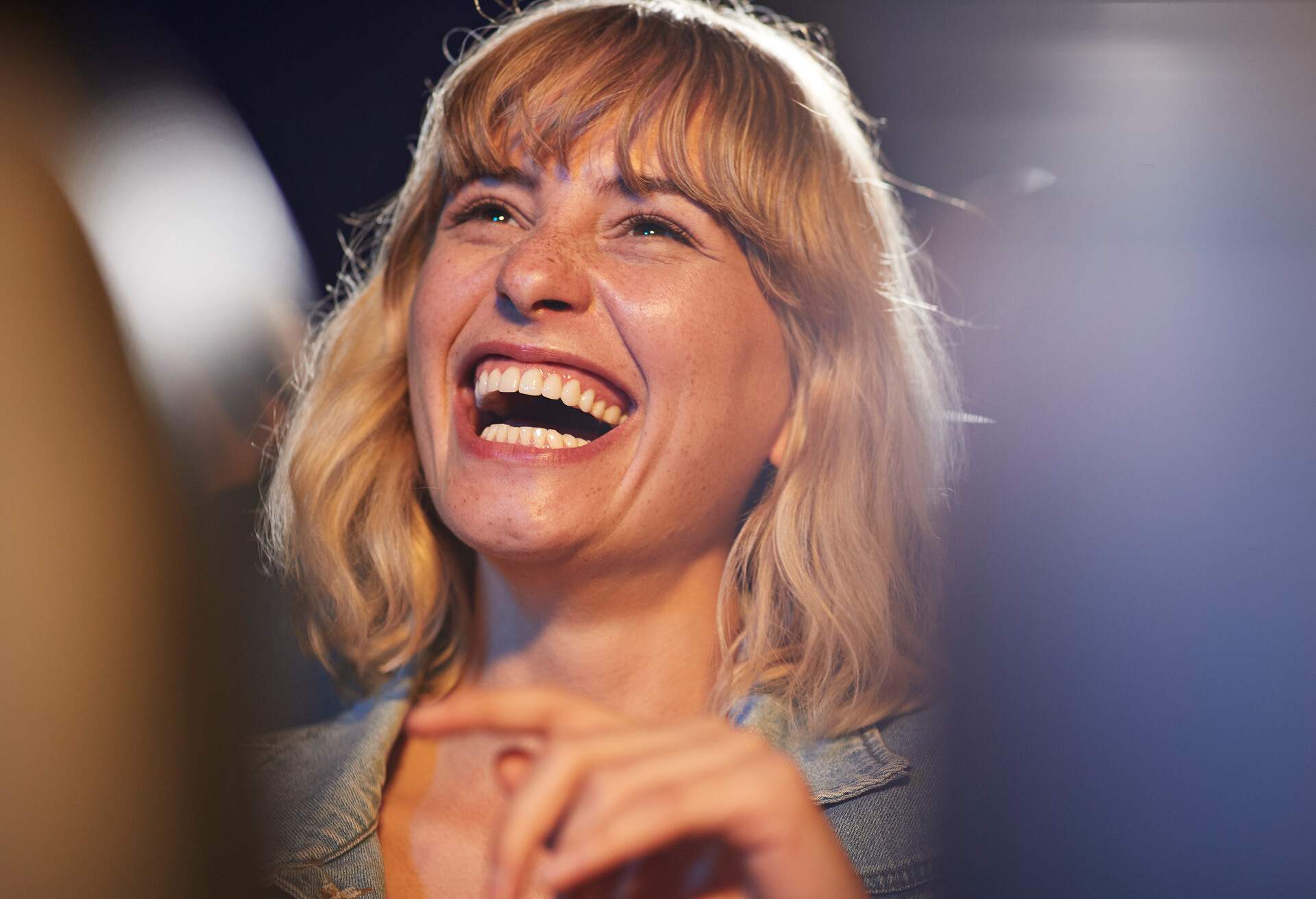 Young woman laughing while enjoying comedy movie in theater