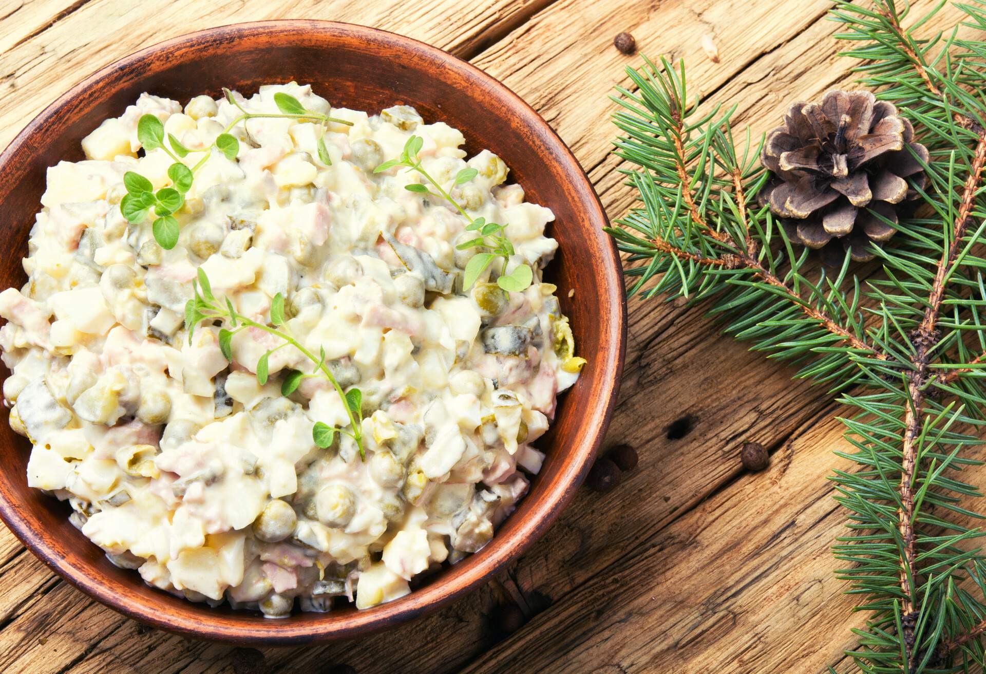 Traditional Russian meat salad Olivier, with meat and vegetables.