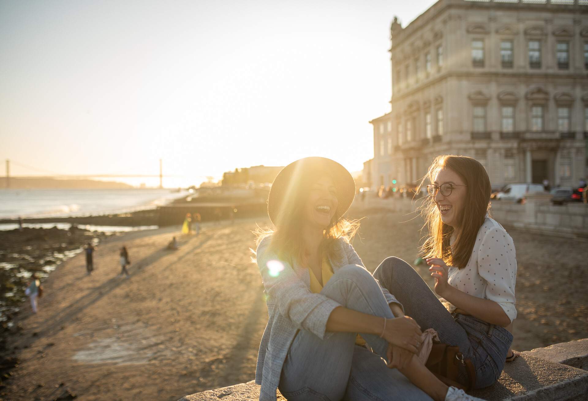 Laughing women having good time in Lisbon on sunny day outdoor.