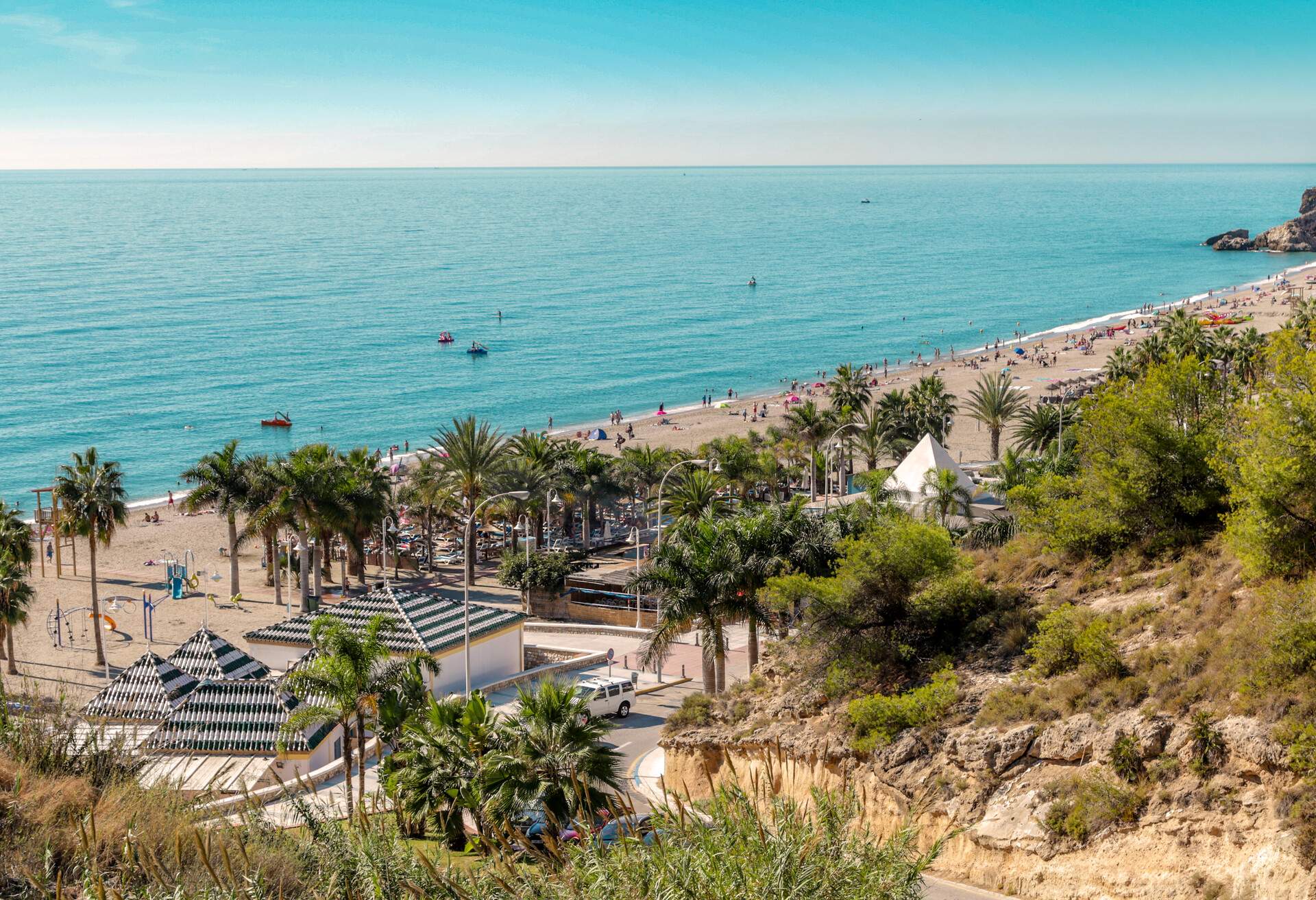 Playa Burriana at Nerja, Costa del Sol, Malaga. Very popular beach with tourists from all over. The beach has multiple restaurants and bars as well as souvenir shopping.