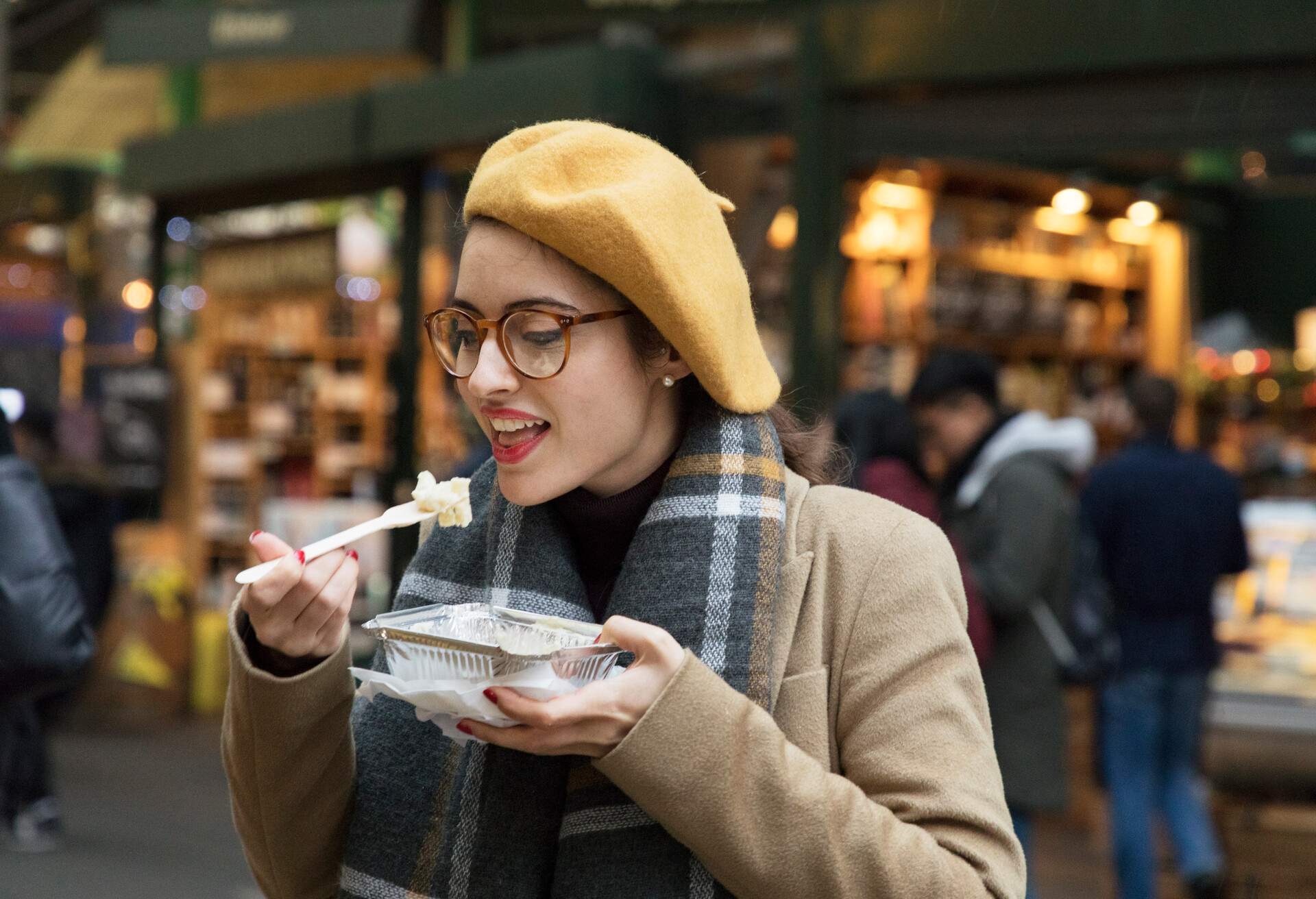Woman eating street food in city