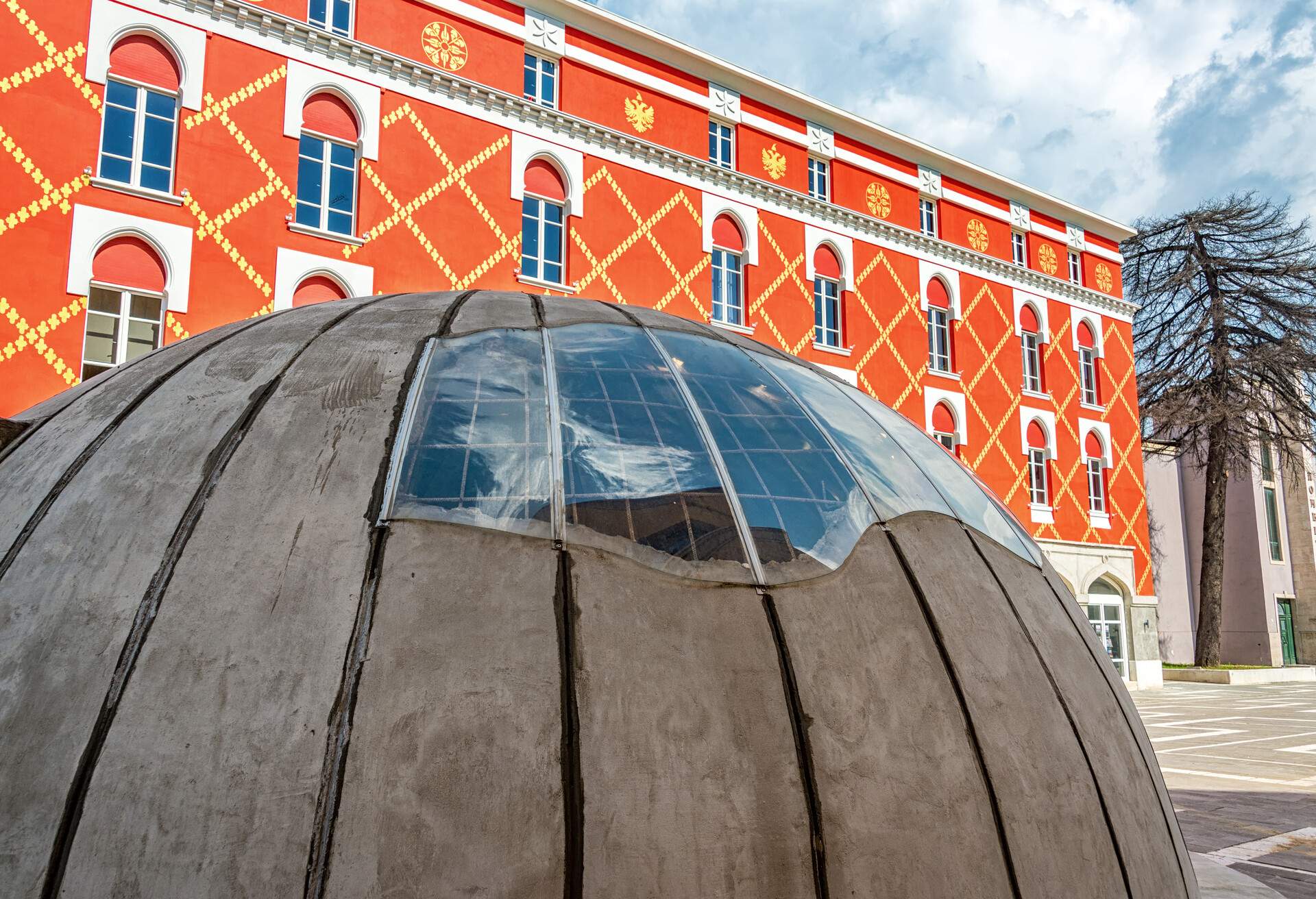 Bunker in downtown Tirana, Albania with the Ministry of Urban Development in the background