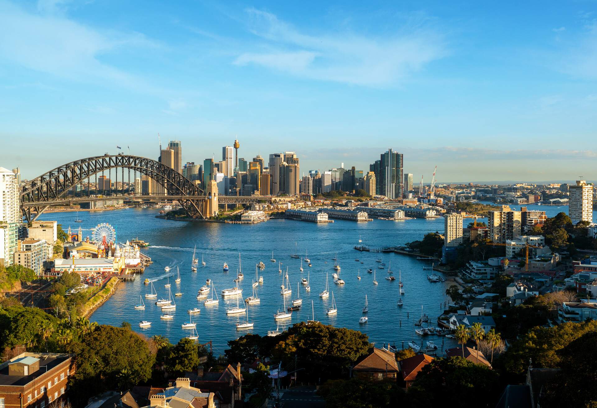 Cityscape image of Sydney, Australia with Harbour Bridge and Sydney skyline during summer day.