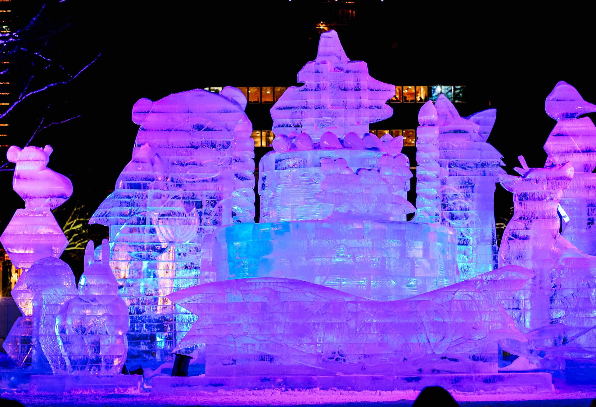 Illuminated ice sculptures of various animals.
