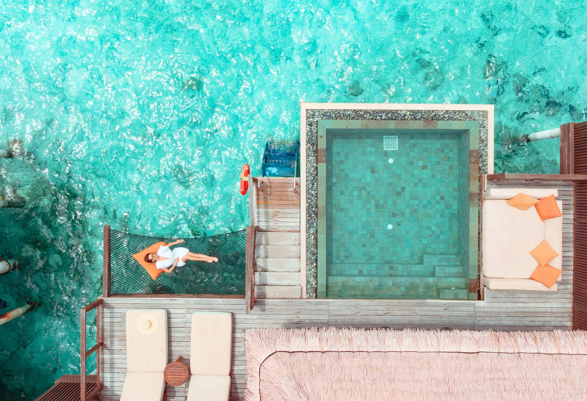 Beautiful woman lying on hammock over ocean in Maldives