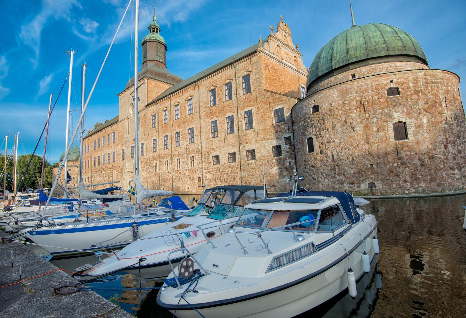 A summer evening at Vadstena Castle in Ostergotland, Sweden. The castle was built in 1545 as a Royal Castle by king Gustav I. Today Vadstena is a popular destination for leisure boats and tourists.