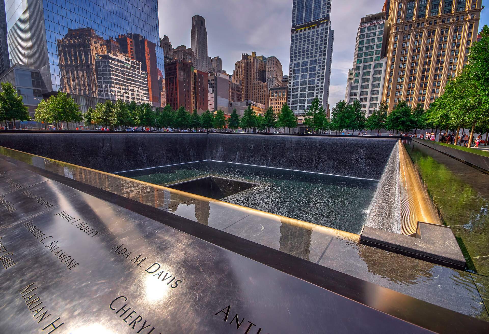 National September 11 Memorial and Museum features a square pool with a square void in the centre, an artificial waterfall, and names engraved in bronze ledges.