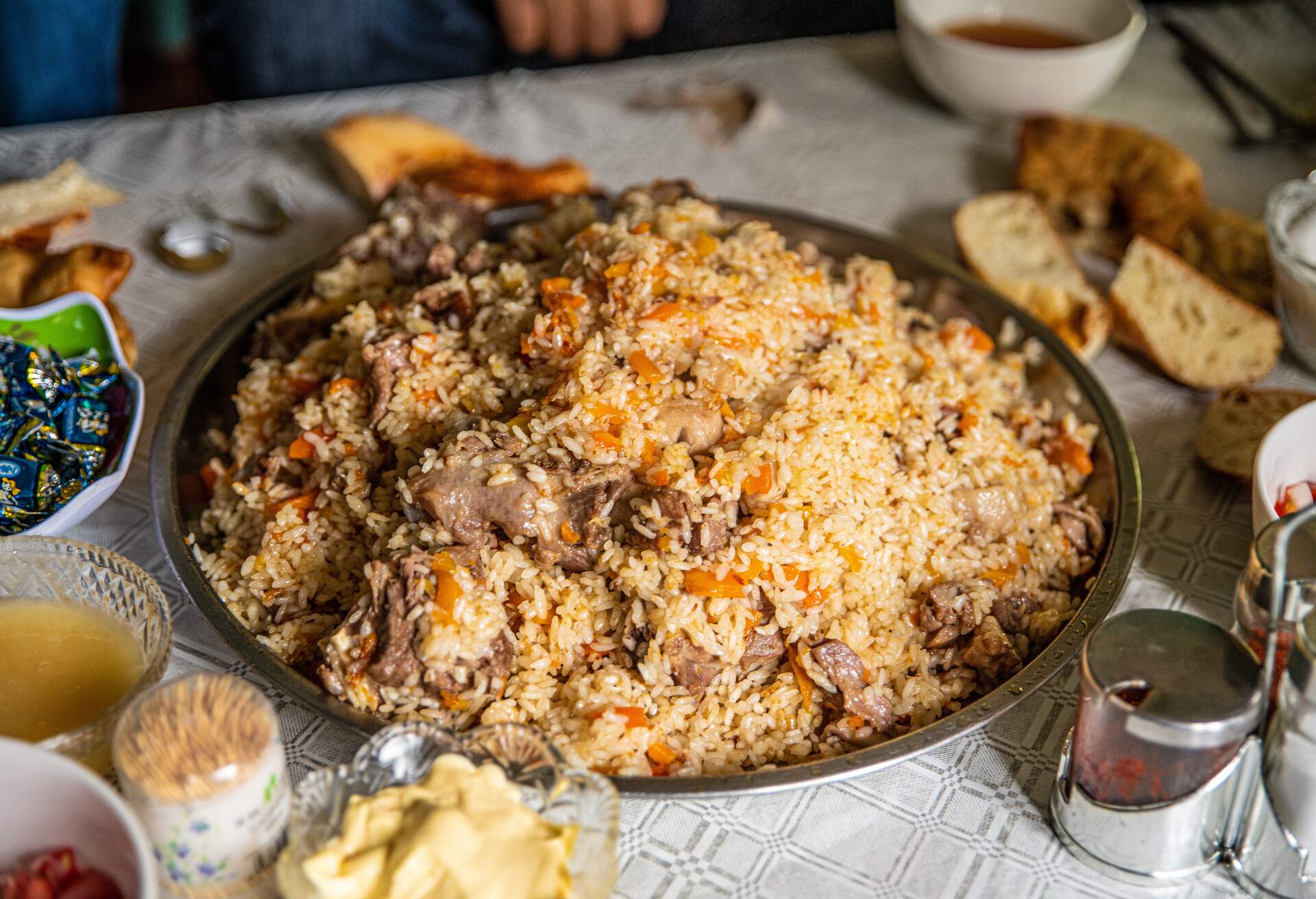 Traditional Central Asian delicious dish Plov prepared by local people, Chon-kemin Valley, Chui, Kyrgyzstan - June 17, 2021