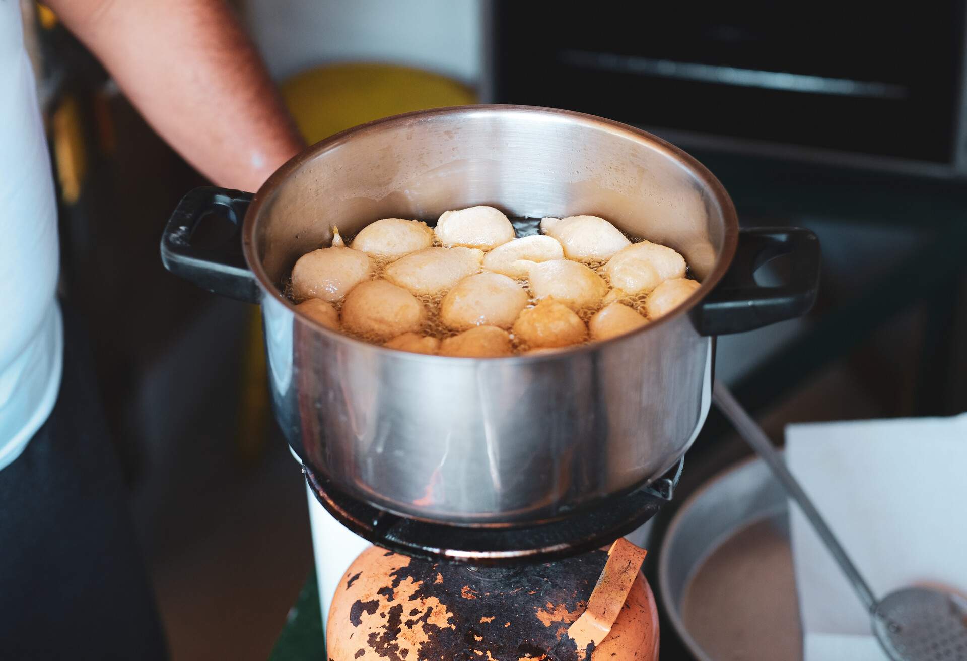 Albanian traditional food dessert petulla in a pan with oil cooking process