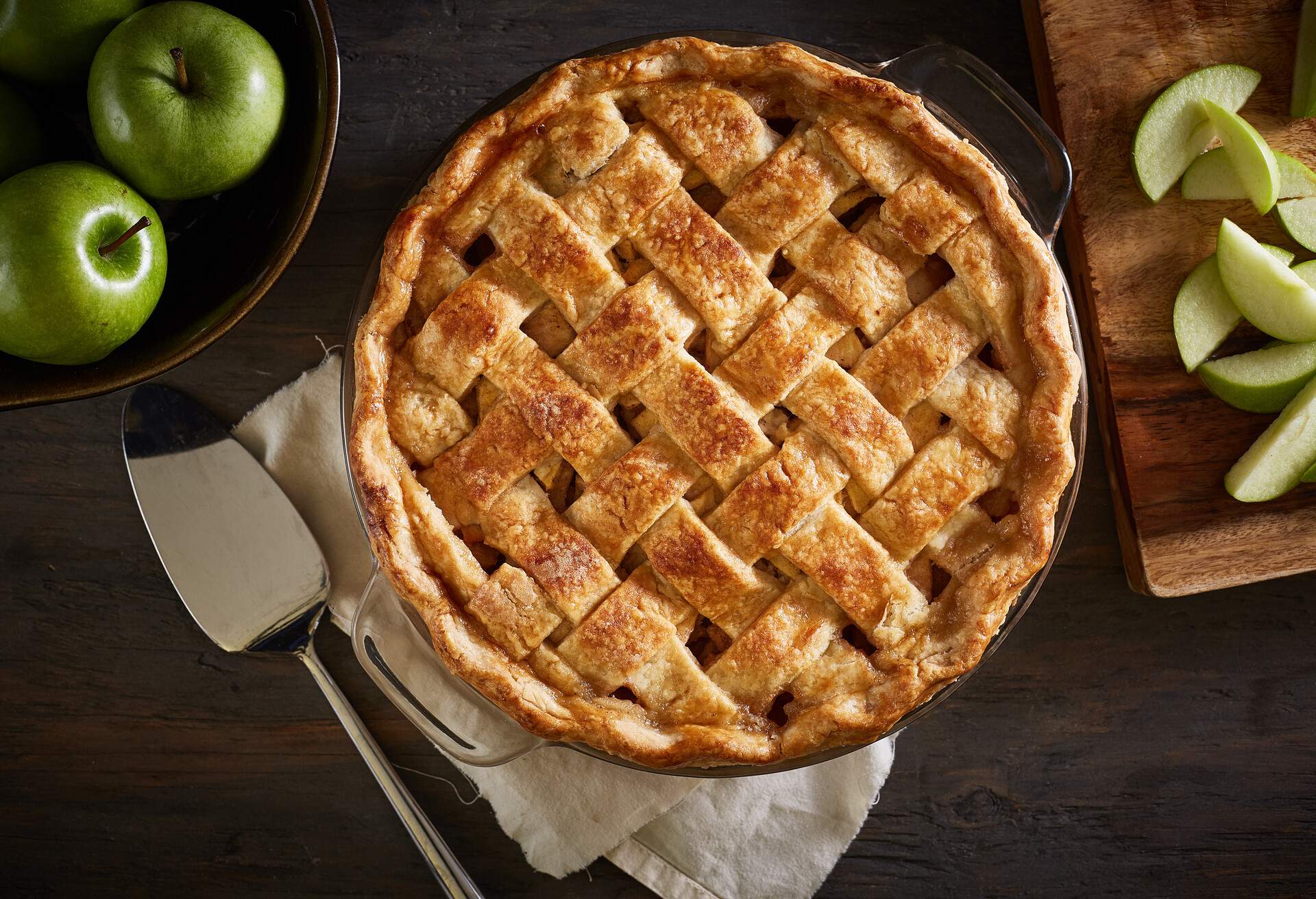 Series of homemade whole and sliced apple pie images on a dark wood surface with ingredients and utensils.