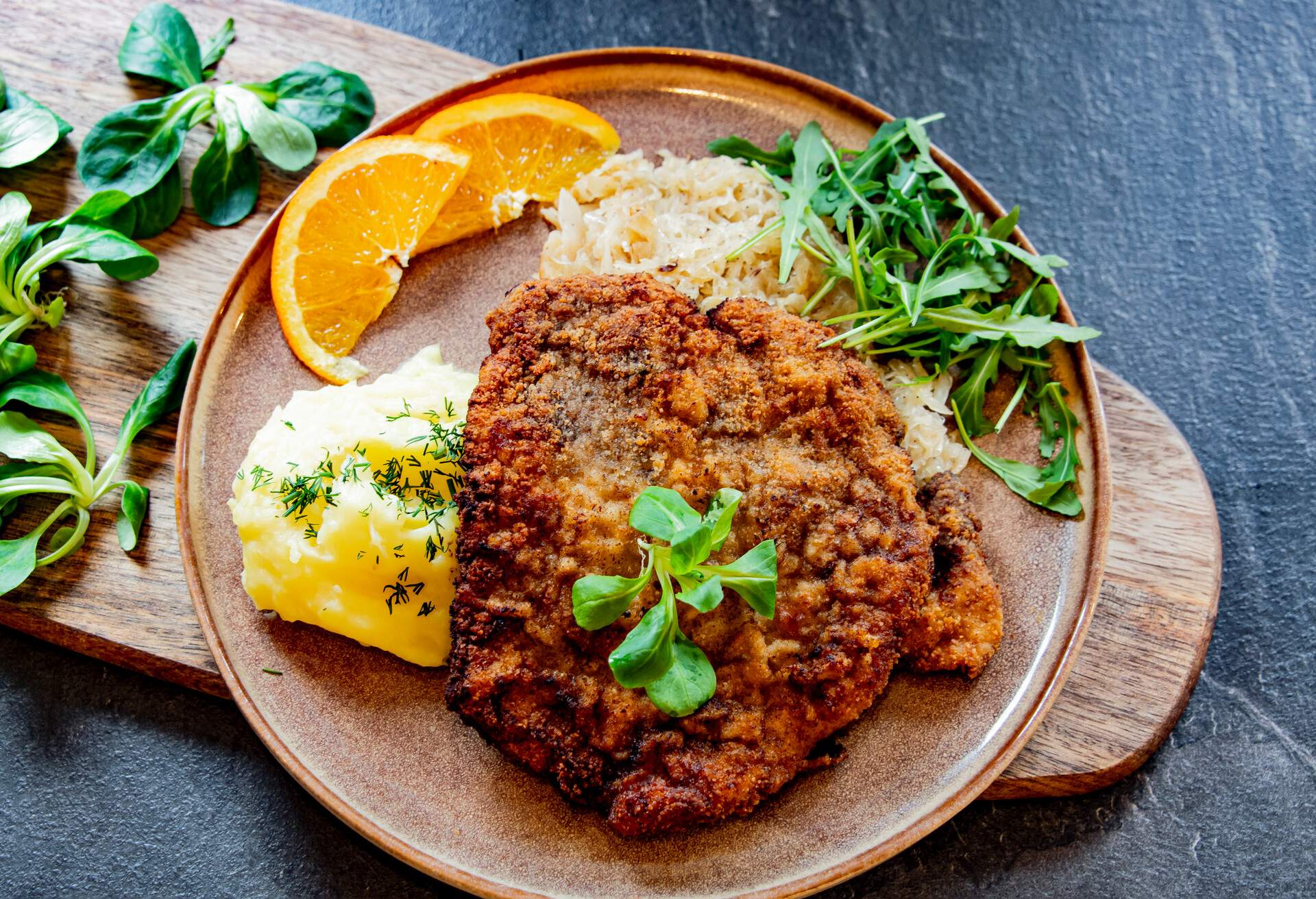 Pork breaded cutlet coated with breadcrumbs with mashed potatoes and cabbage