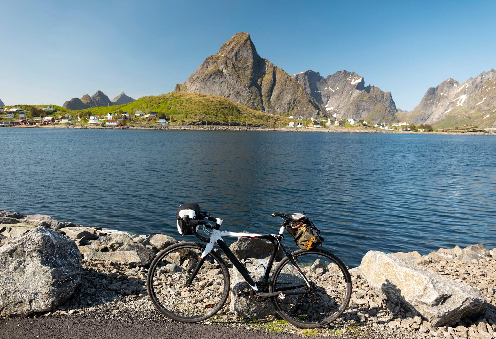 Cycle touring is a great way to get around the Lofoten Islands. The roads are mostly low lying and cycling friendly, skirting the coastline. The idea is to travel light and enjoy the stunning scenery as seen in this image of Reine.