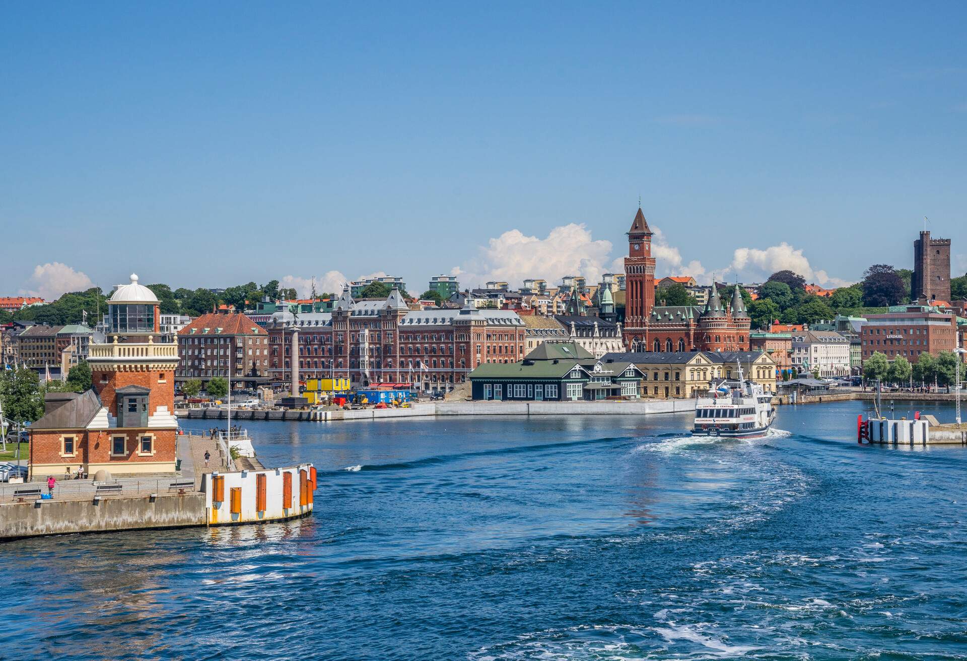 the Baltic Sea coastal city of Helsingborg with view of the harbour lighthouse and the prominent towers of the Helsingborg City Hall and the Karnan medieval fortress, Scania, Sweden, July 24, 2016